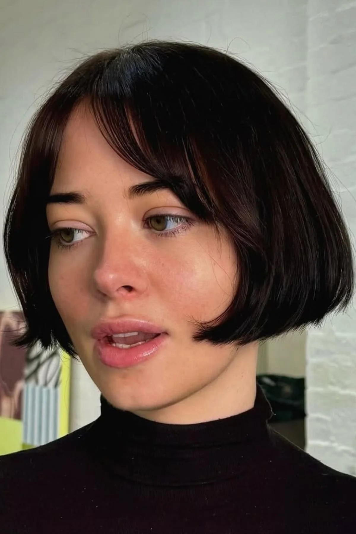 Girl wearing a Blunt Bob Haircut with Tucked-In Ends (The “French Girl” Look), styled with subtle inward bends for a chic Parisian vibe.