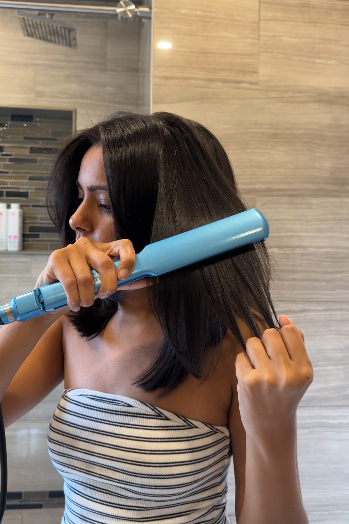 flat-ironing a section of thick hair to a glass-smooth finish