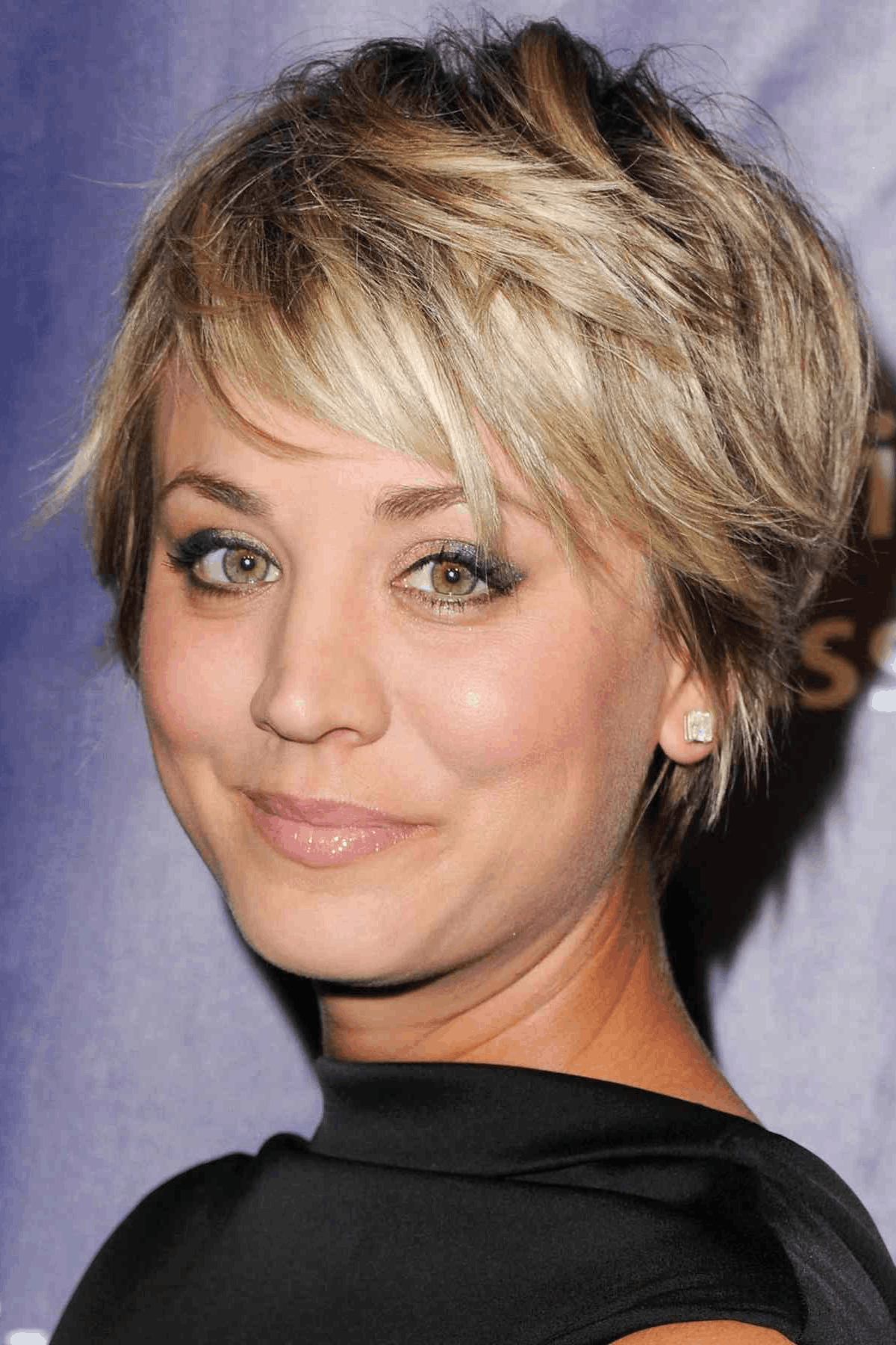 Side-profile image of a person wearing Shaggy Long Pixie with Choppy Layers, highlighting uneven, choppy layers with movement through the crown and a softly tapered neckline.