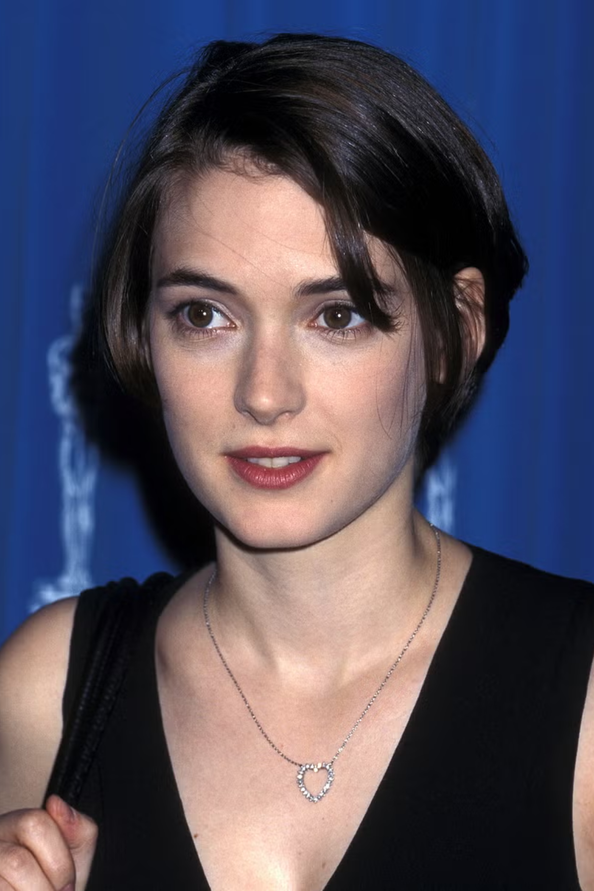 Woman wearing a Bixie Cut (Bob + Pixie) haircut with soft tapering and reduced bulk for an easy, breezy summer style.