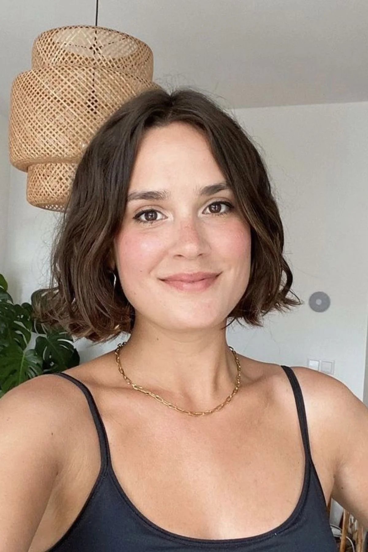 Woman with a Soft Layered Bob haircut featuring blended chin-to-collarbone layers that create natural movement and effortless volume.