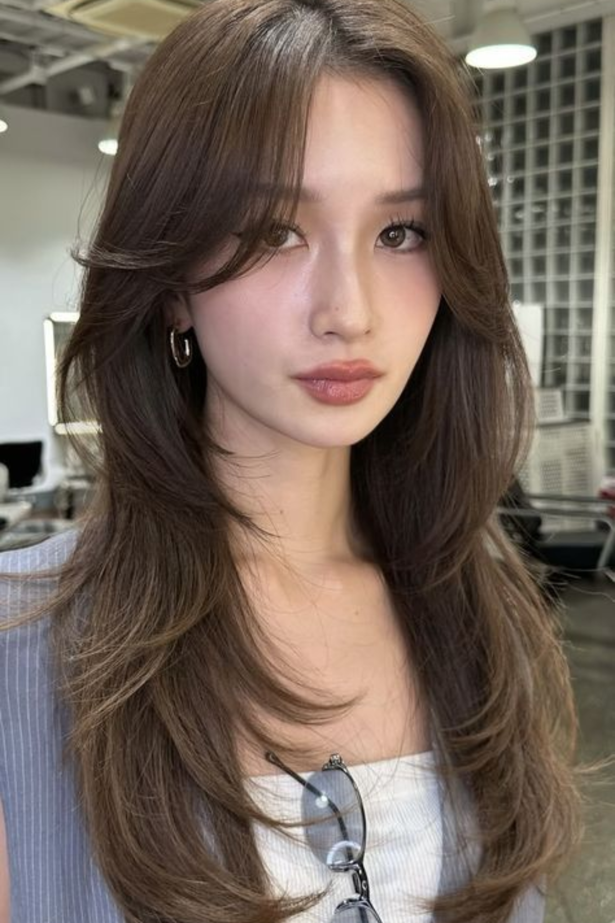 Girl with Long Face-Framing Layers haircut, showcasing long hair with layered pieces that softly contour the face.