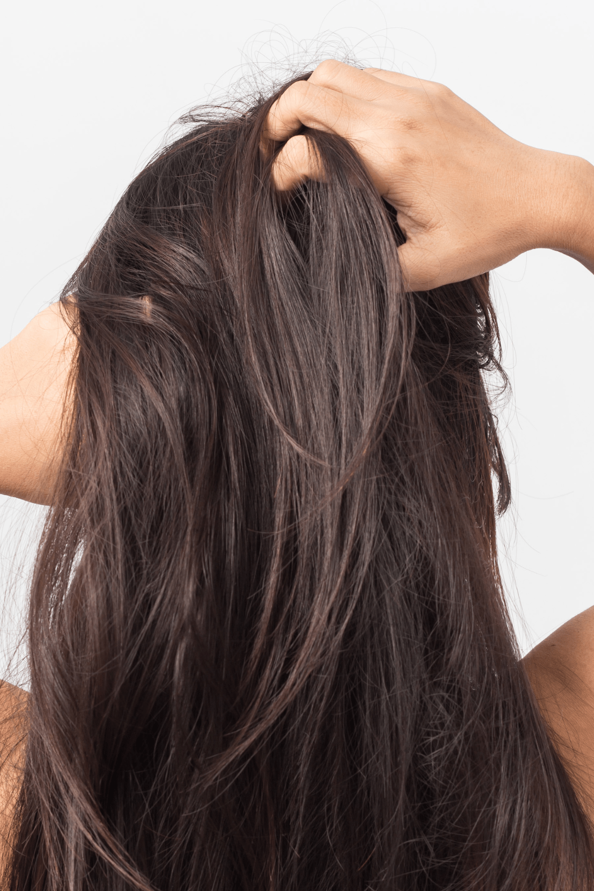 an image of a women itching her scalp