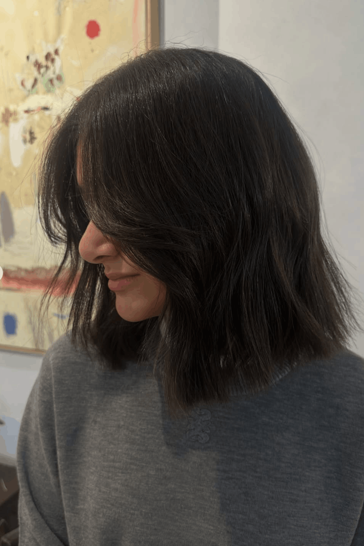 Woman with a collarbone-length lob, styled with light layers and natural movement for a soft, lightweight look.