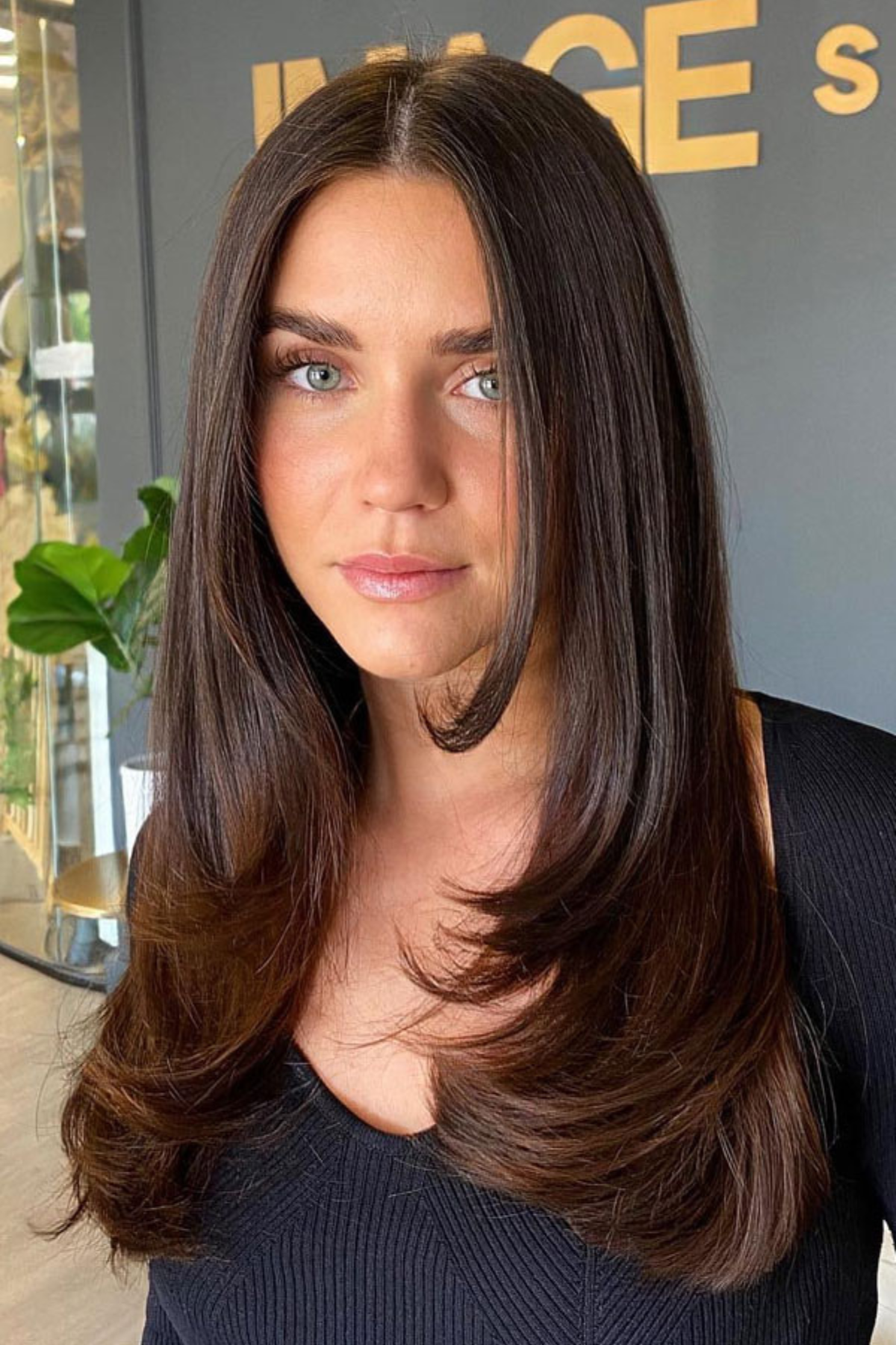 Girl with Long Layers with Weight Removal haircut, featuring internal layering that reduces heaviness for summer comfort.