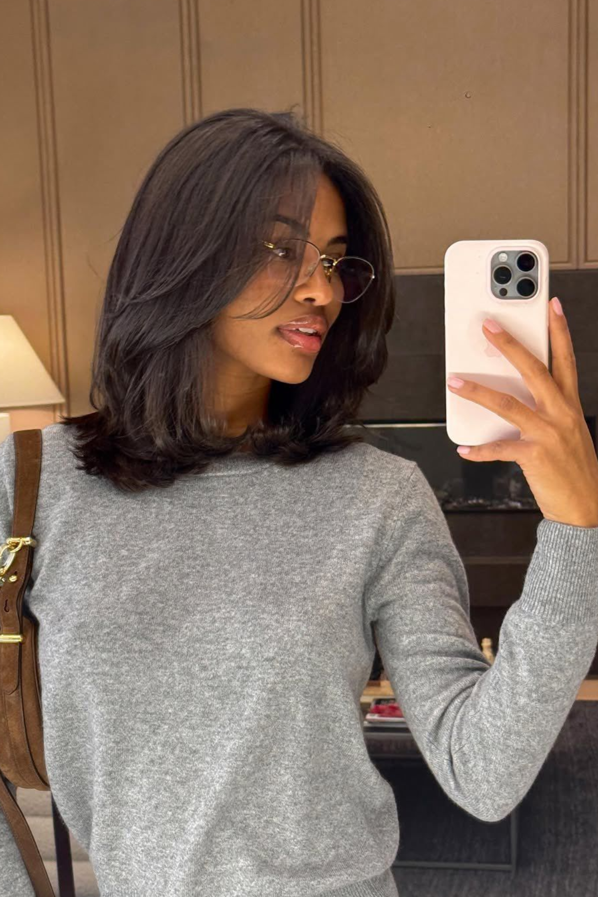 Woman with a Layered Collarbone Lob haircut featuring a long bob length that grazes the collarbone with blended layers for movement.