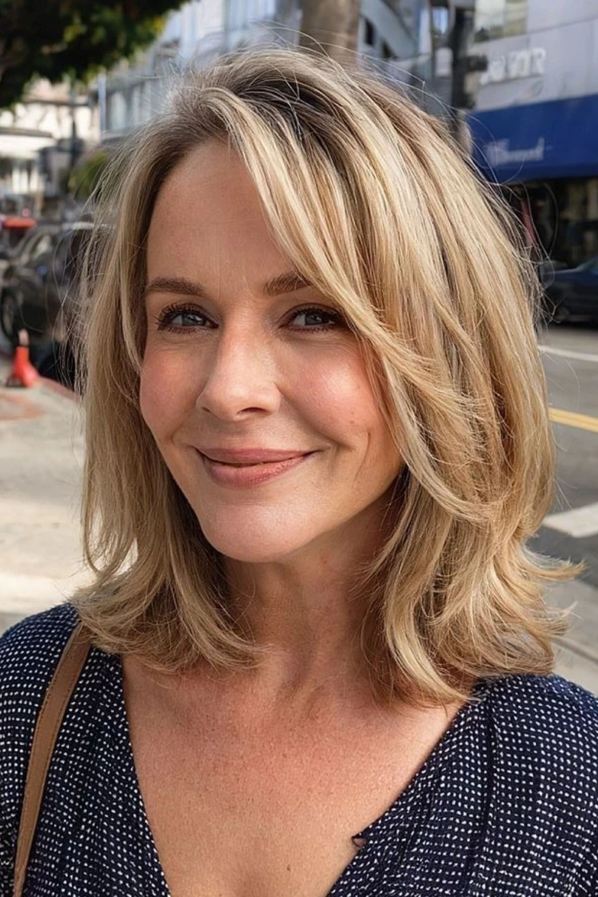 Collarbone-length lob with a soft bend at the front on a woman in her fifties