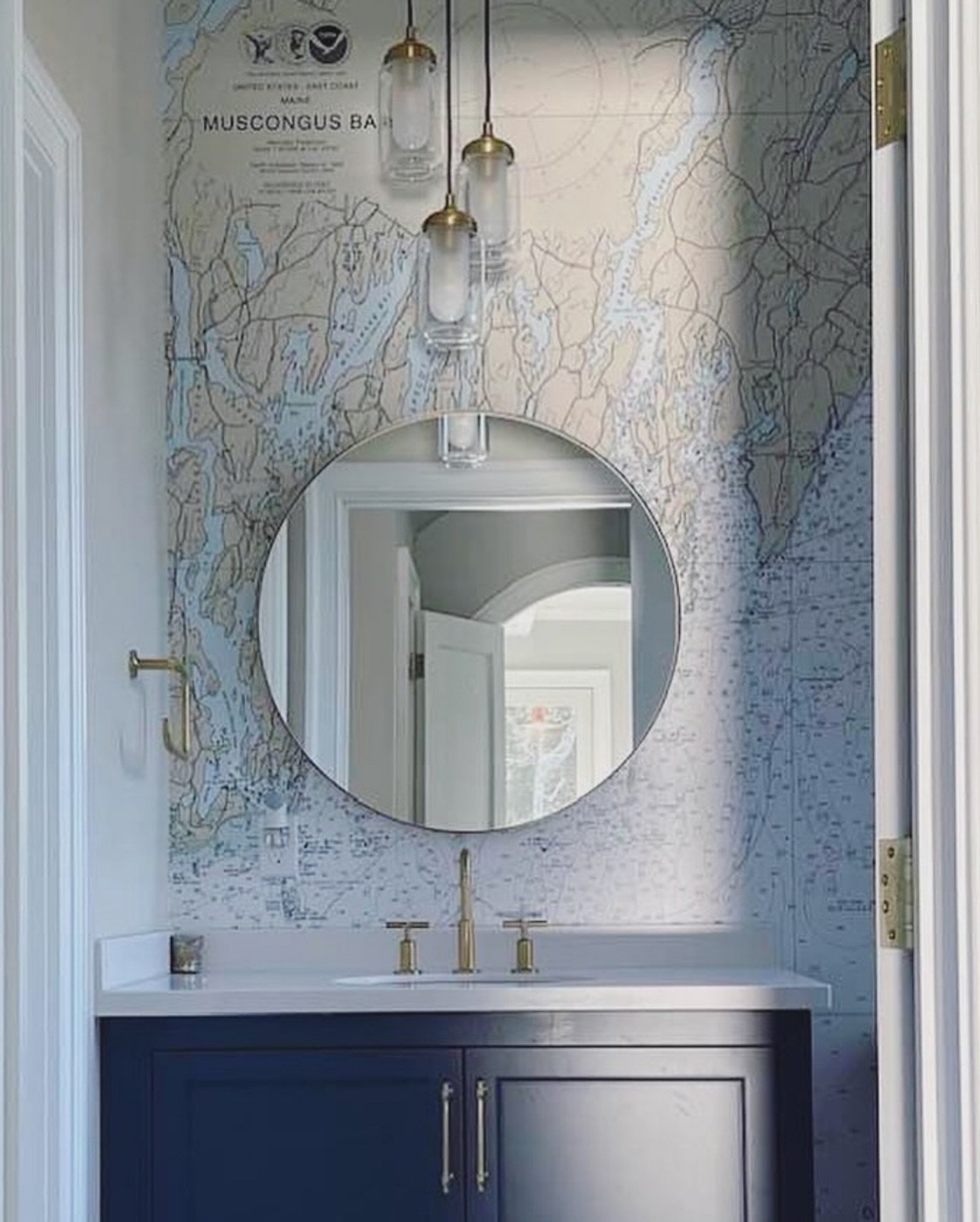 This powder room turns up the charm with a custom nautical chart of Muscongus Bay, Maine&mdash;a favorite stretch of coastline brought to life as a full accent wall. The bold lines, soft blues, and coastal details make this small space feel like a ge