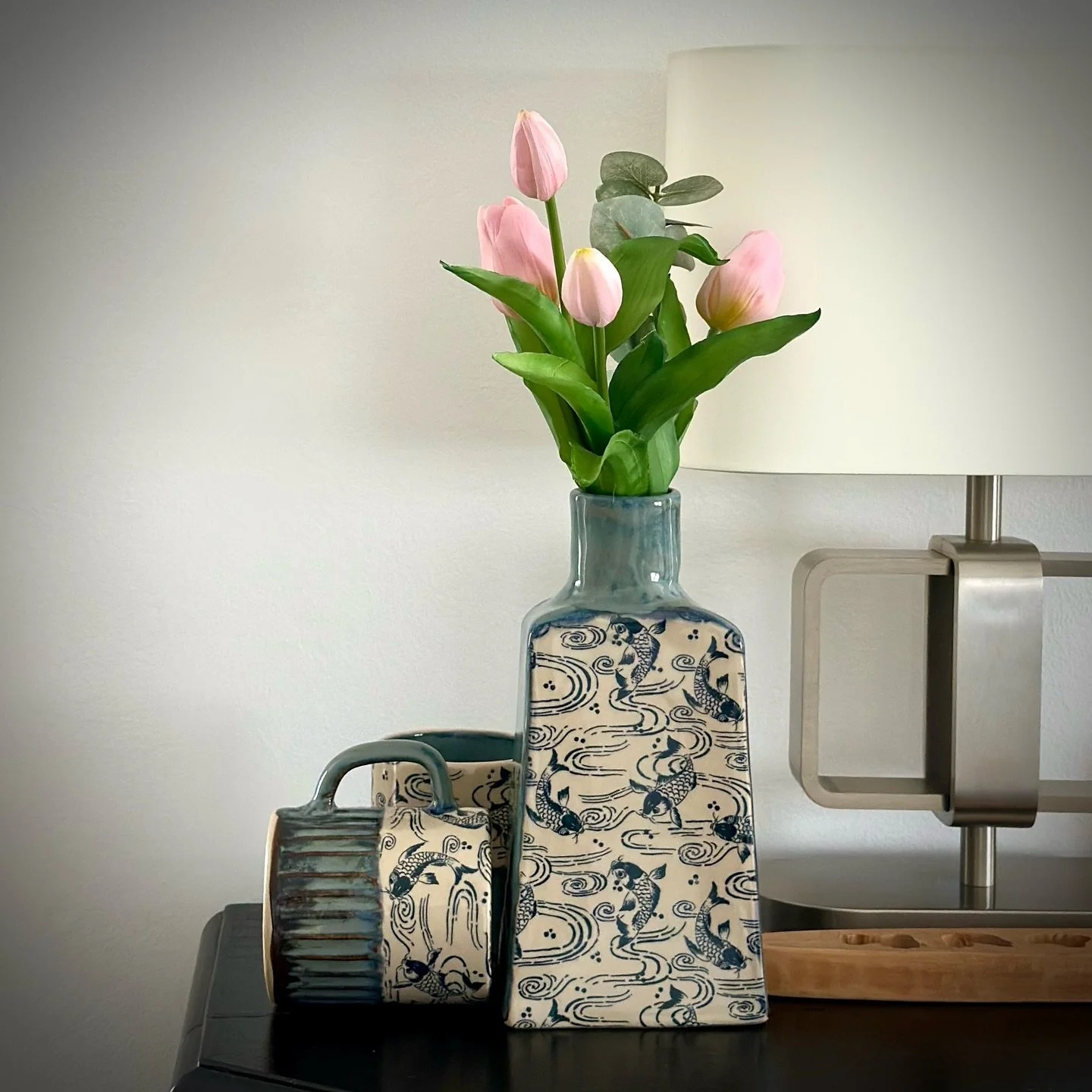 I love making bottlevases. They&rsquo;re so versatile. This is my latest edition with koi fish and a blue/greyish glaze that is one of my favorites. You might recognize the glaze from my dragonfly series. A perfect mix and match. 

#potteryadventures