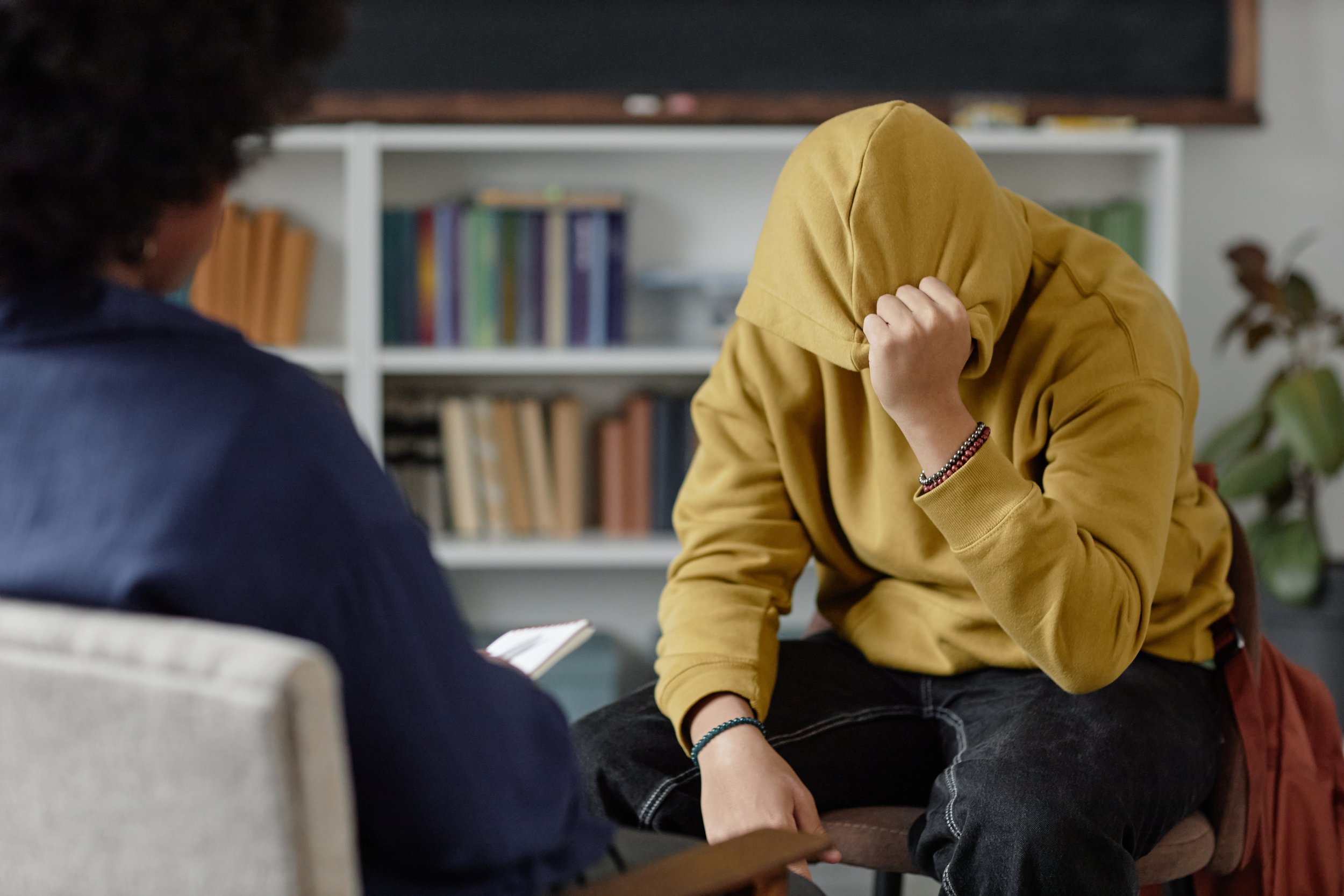 A person leaning forward during a trauma therapy session with a therapist, representing EMDR therapy and intensive treatment at Room for Change.