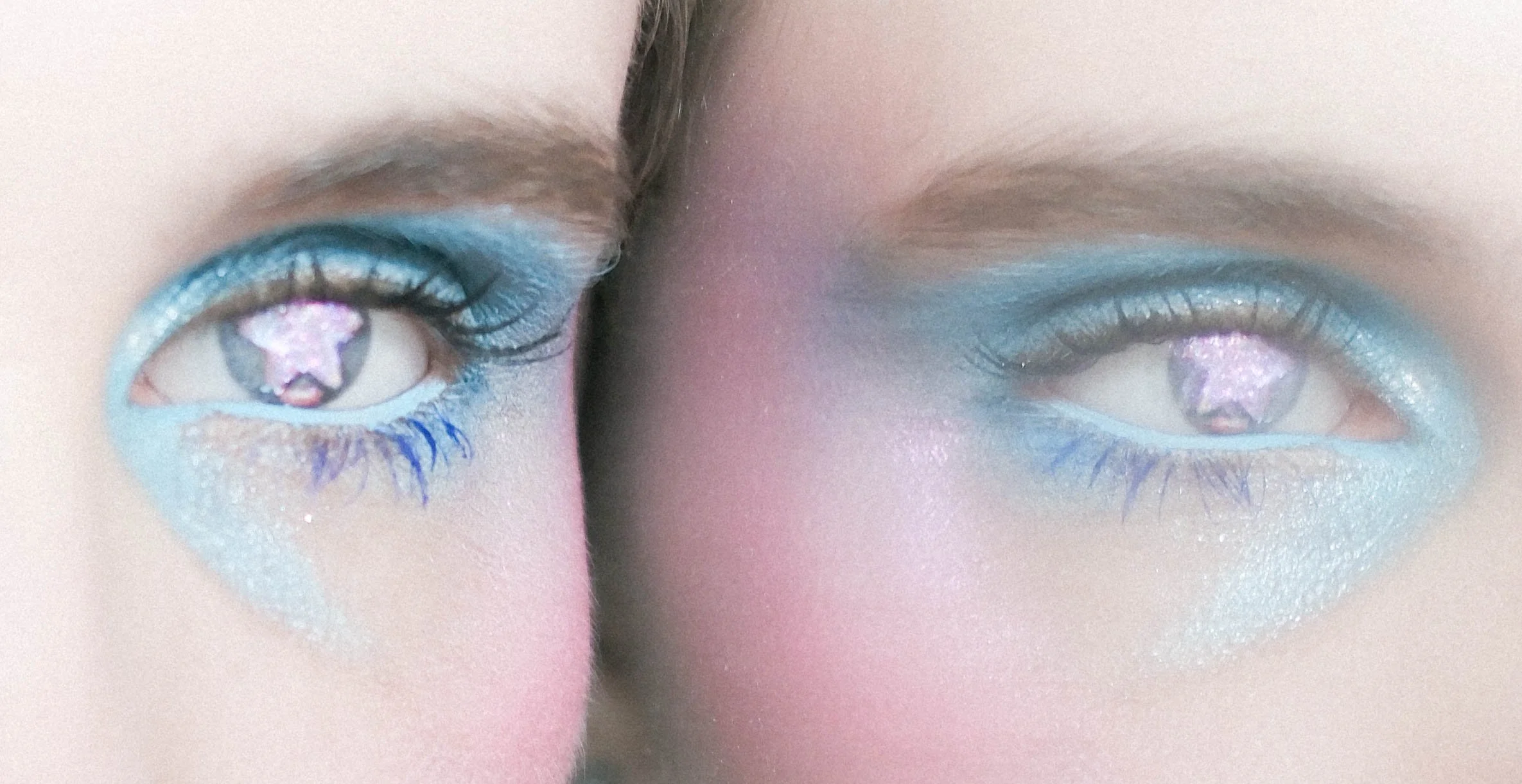 Close-up of a person's eyes with colorful, glittery makeup and digital images reflected in the pupils.