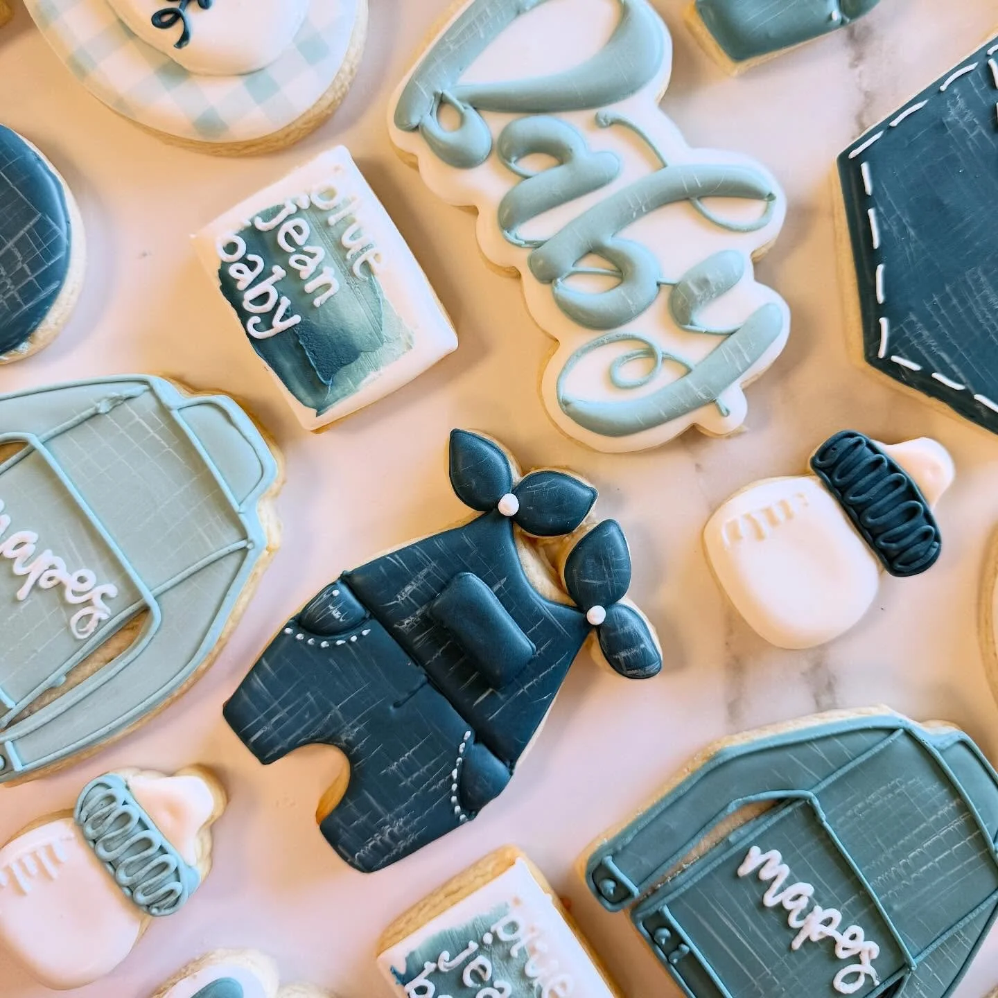 👖💙 Tiny denim dreams come true! This Blue Jean Baby shower set is dressed to impress &mdash; and even cuter than a newborn pair of overalls.  #scottsdalecookieco #scottsdalecookies #localfirstaz #BlueJeanBaby #bluejeanbabycookies #BabyShowerCookies