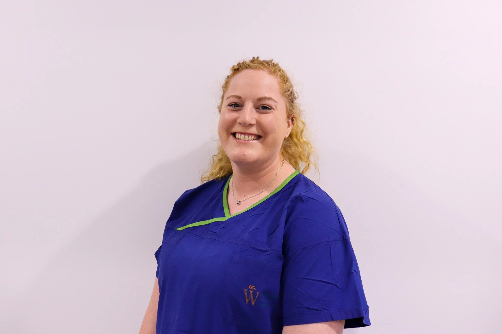 photo of Ash smiling in scrubs