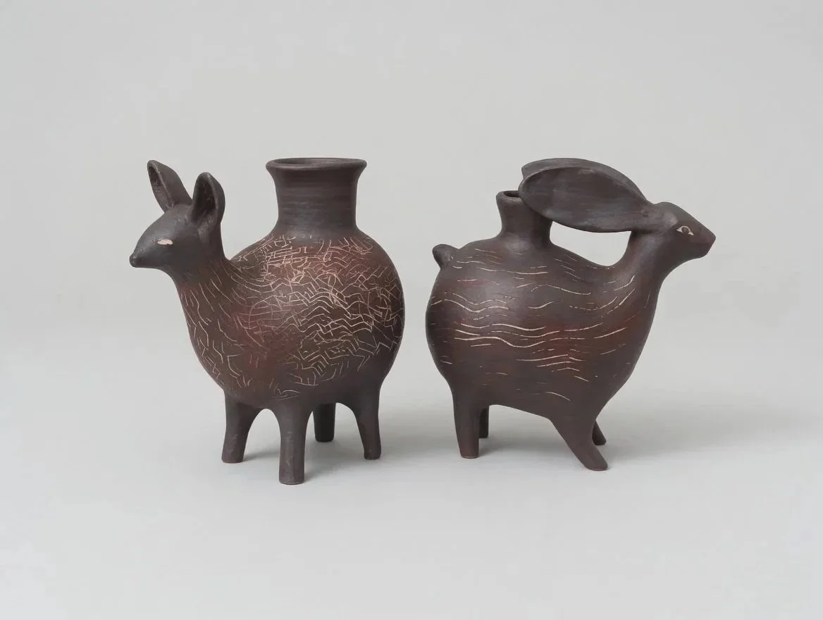 Dark brown coyote and rabbit vessels, pre-columbian influenced.