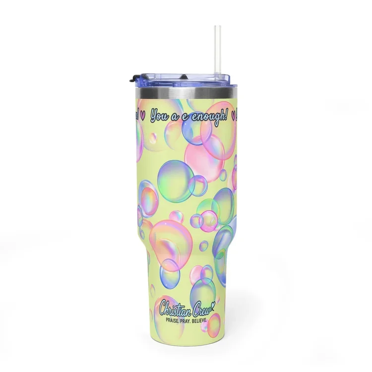 A colorful tumbler with bubbles and pastel colors, featuring the text 'You are enough!' and 'Christian Crew: Praise Pray Believe,' with a straw on top.