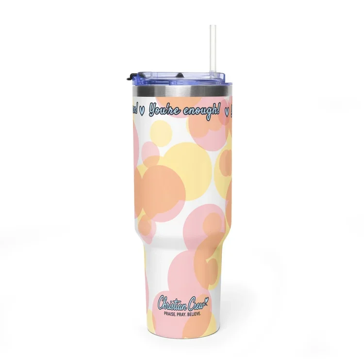 A travel tumbler with a pastel-colored bubble pattern, 'You’re enough!' written across the top, and 'Christian Crew' with the tagline 'PRAISE. PRAY. BELIEVE.' near the bottom.