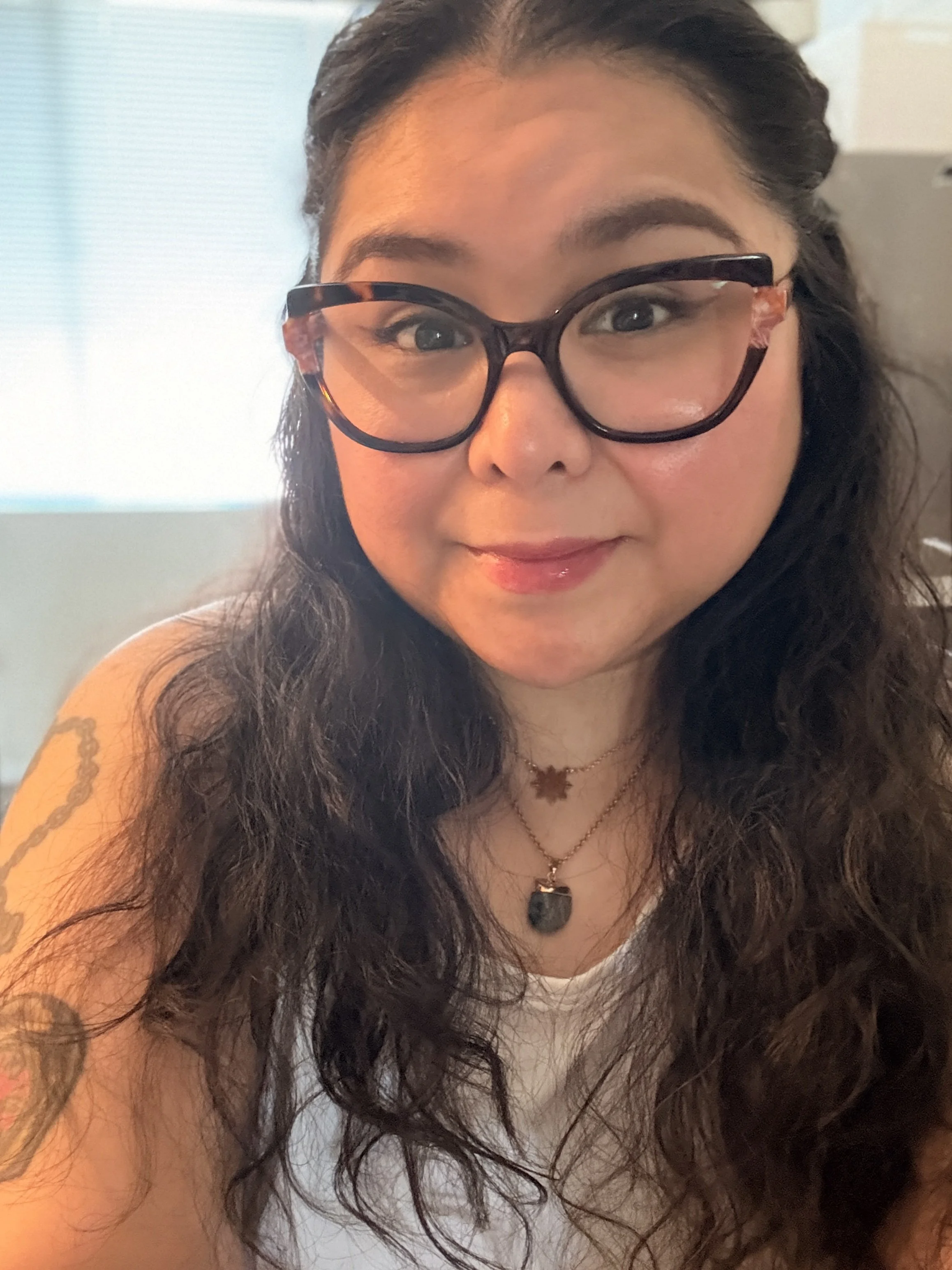 Photo of a Filipina woman wearing glasses.