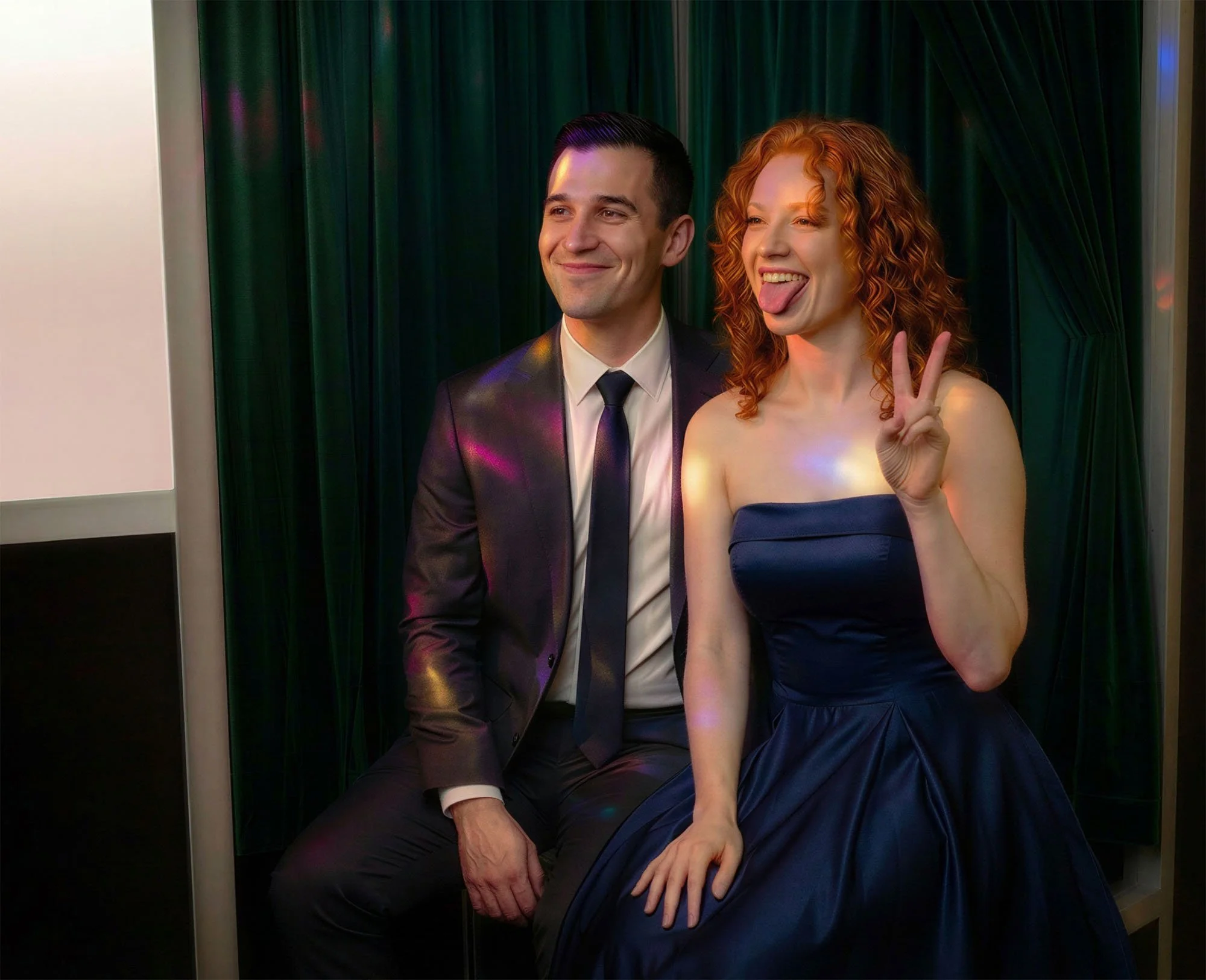 a happy couple using an enclosed photo booth