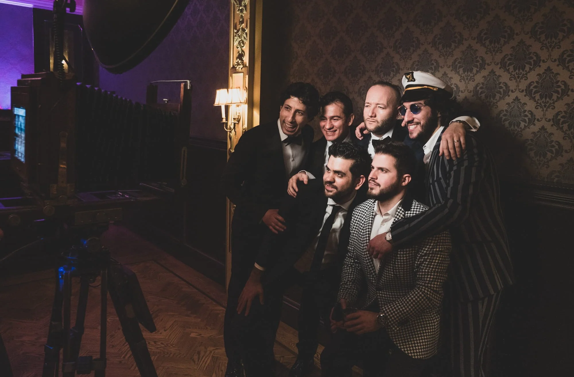 Group of friends using a open-air photobooth.