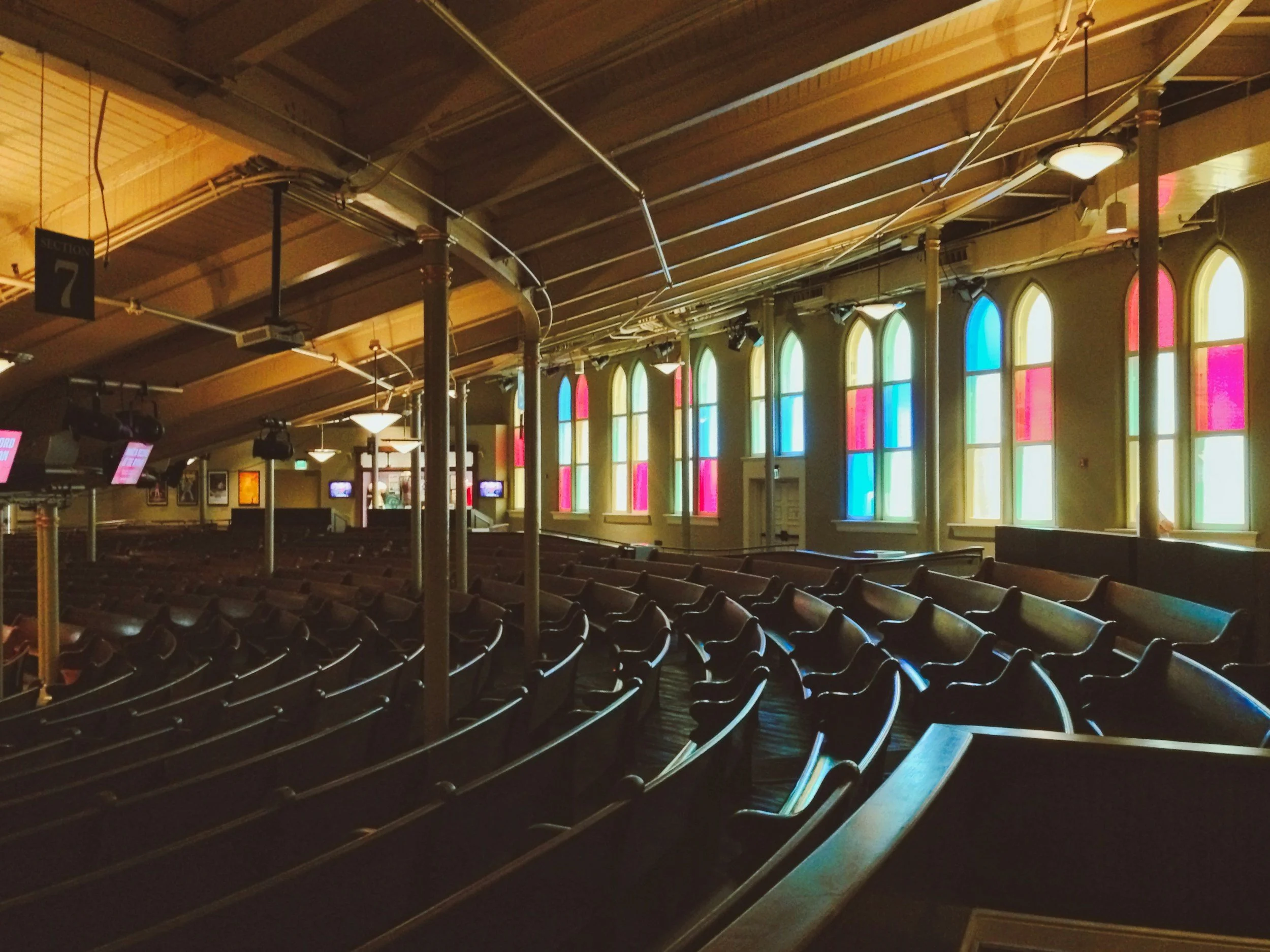 Pews and stained glass windows inside the historic Ryman Auditorium in Nashville