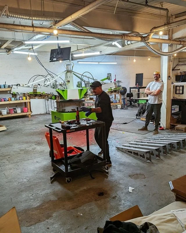Technician breaking down print press to be packaged and transported to new print shop
