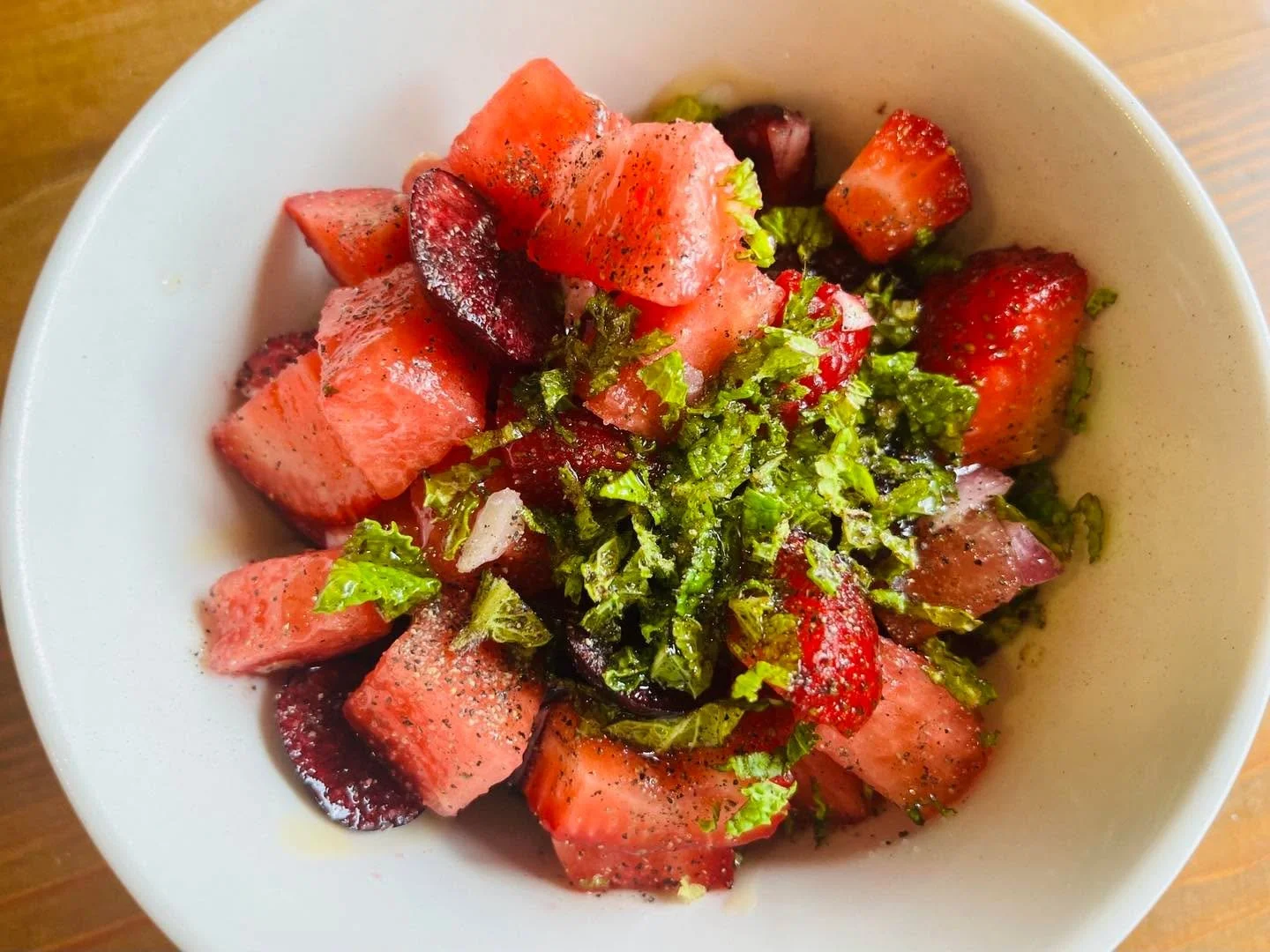 Watermelon, cherries, raspberries and strawberries with red onion and fresh mint a touch of olive oil and honey balsamic vinegar and a drizzle of honey.  Chill it and eat alone for a sweet and fresh and healthy snack or serve over quinoa or purple ba