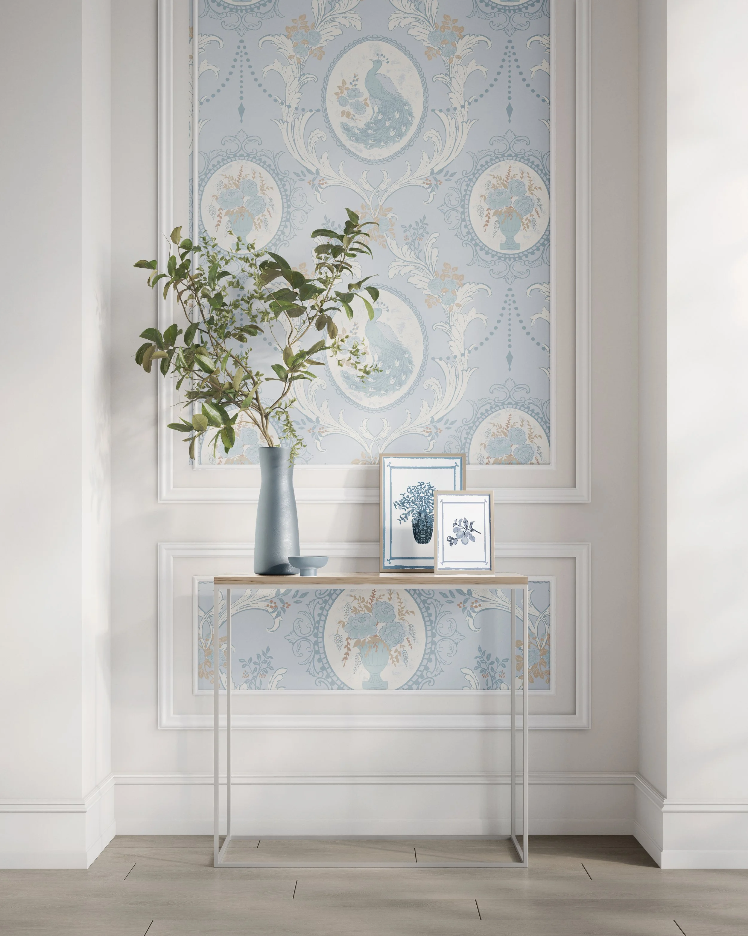 The Drawing Room baroque peacock medallion wallpaper in powder blue and cream displayed in an elegant entryway with white paneling and console table by The Bright Leaf Design