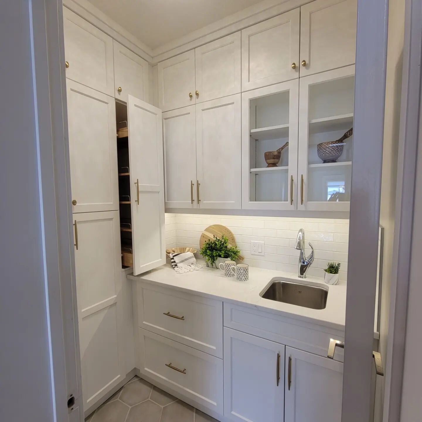 We upgraded from a tiny pantry to this luxurious butlers pantry by closing off the second access to the kitchen through the garage mud room. Had some custom cabinets built to utilize the space in both rooms creating lots of storage and an extra prep 