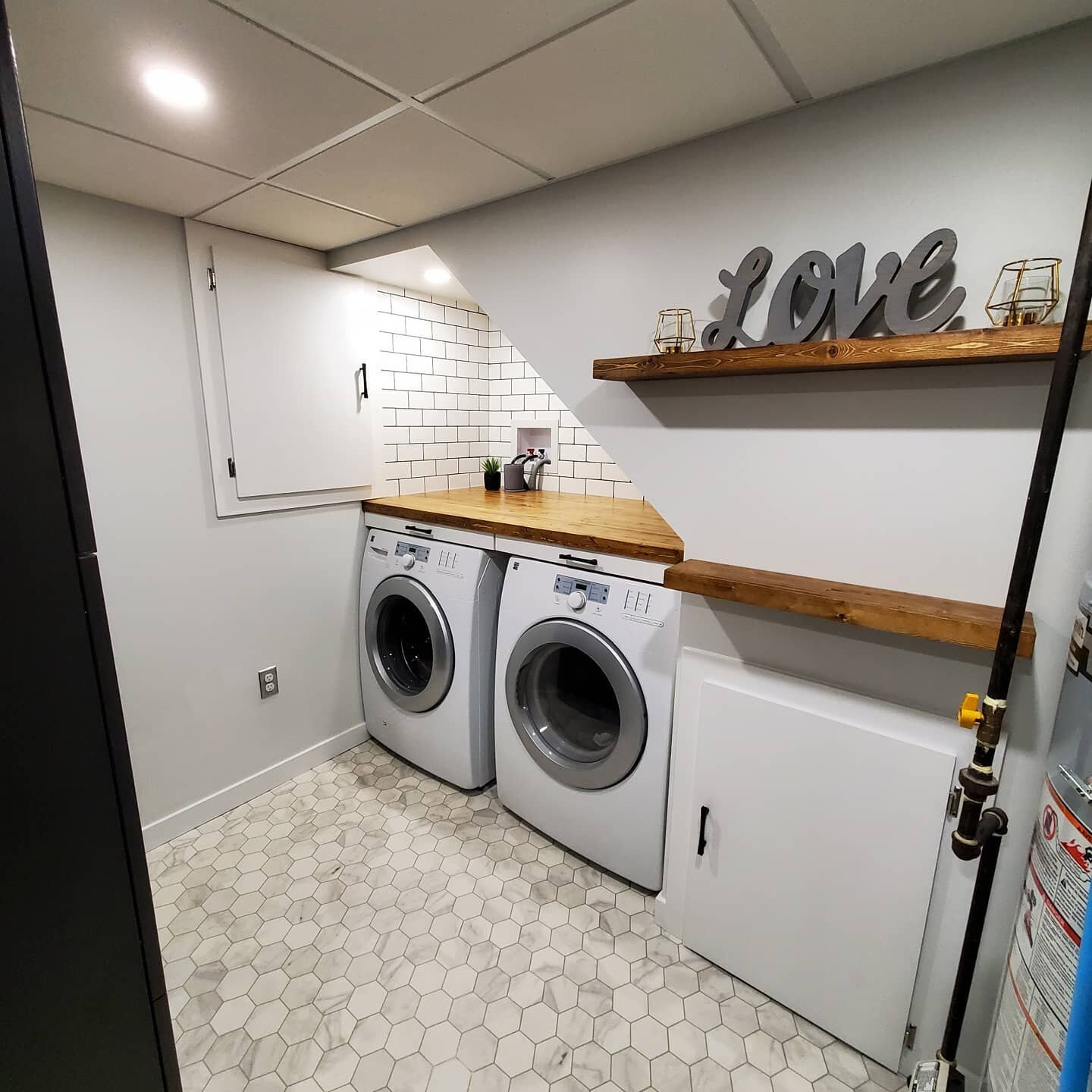 This laundry room turned out great! Built in sliding drying racks, custom countertop with matching floating shelves, hexagon flooring finished off with some subway tiles. What a big difference from the unfinished laundry room that we started with!
.
