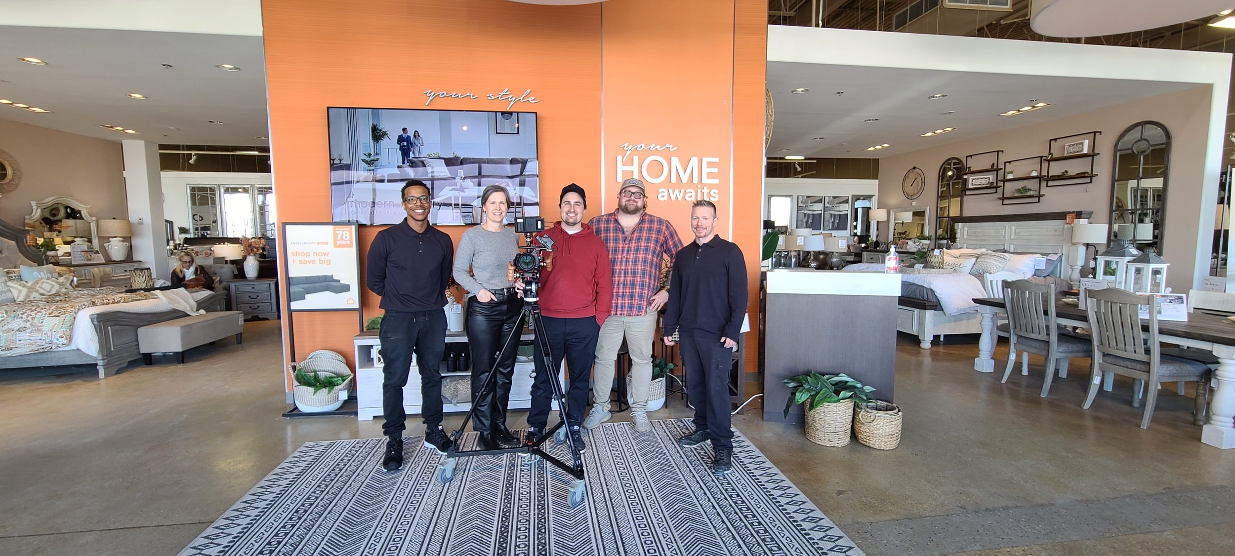 Josh Diaz from Videos by Josh poses with his film crew on an Ashley HomeStore video shoot.