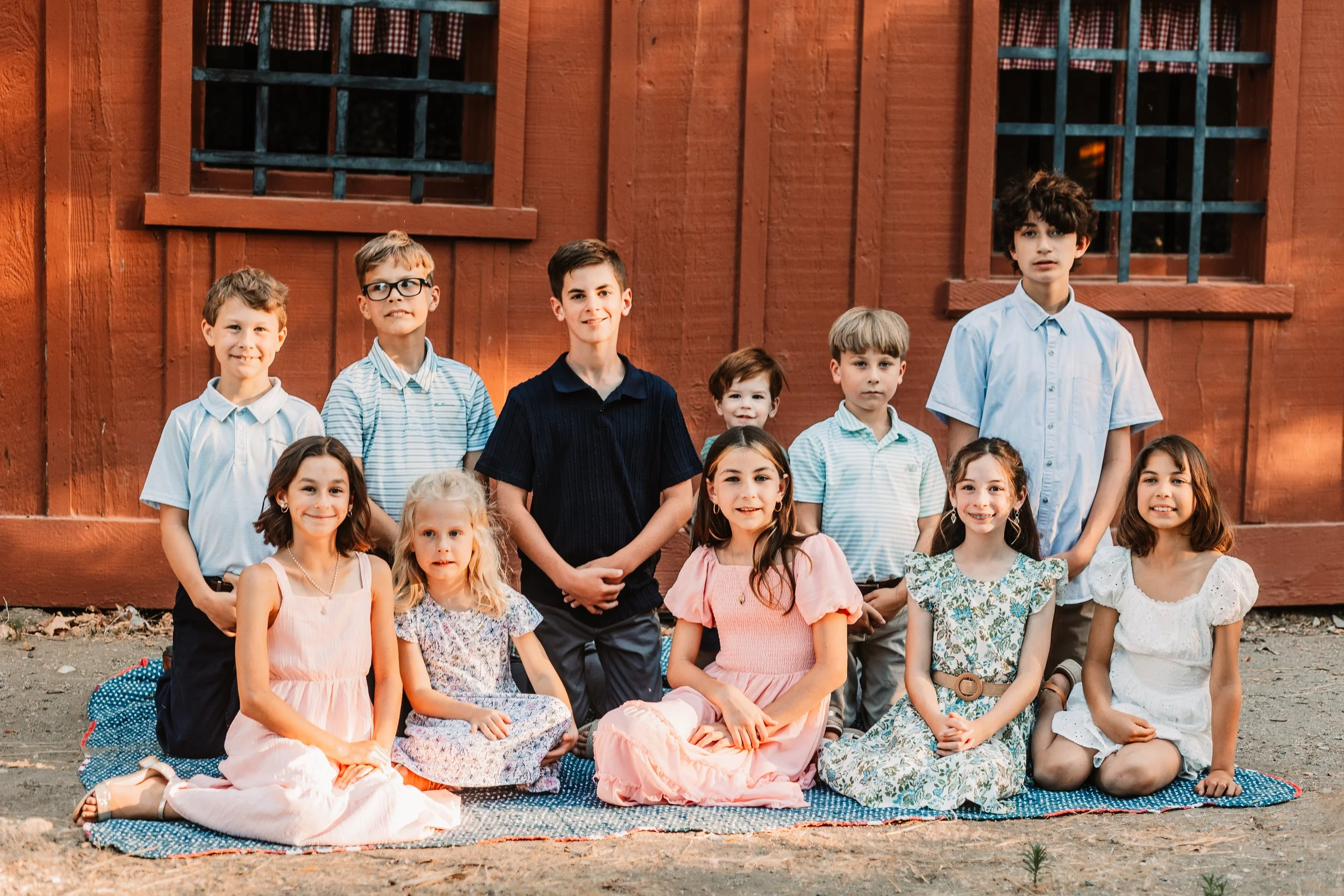 Eleven grandchildren posed in front of the historic Walker Cabin at Placerita Canyon, Santa Clarita family photography