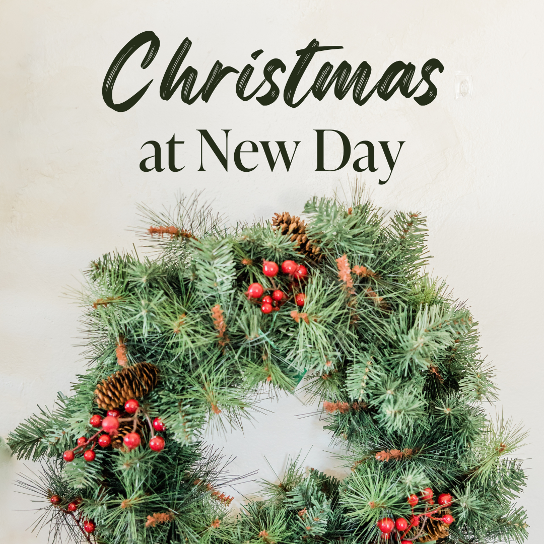 Christmas wreath with pinecones and red berries below the text 'Christmas at New Day' on a cream background.
