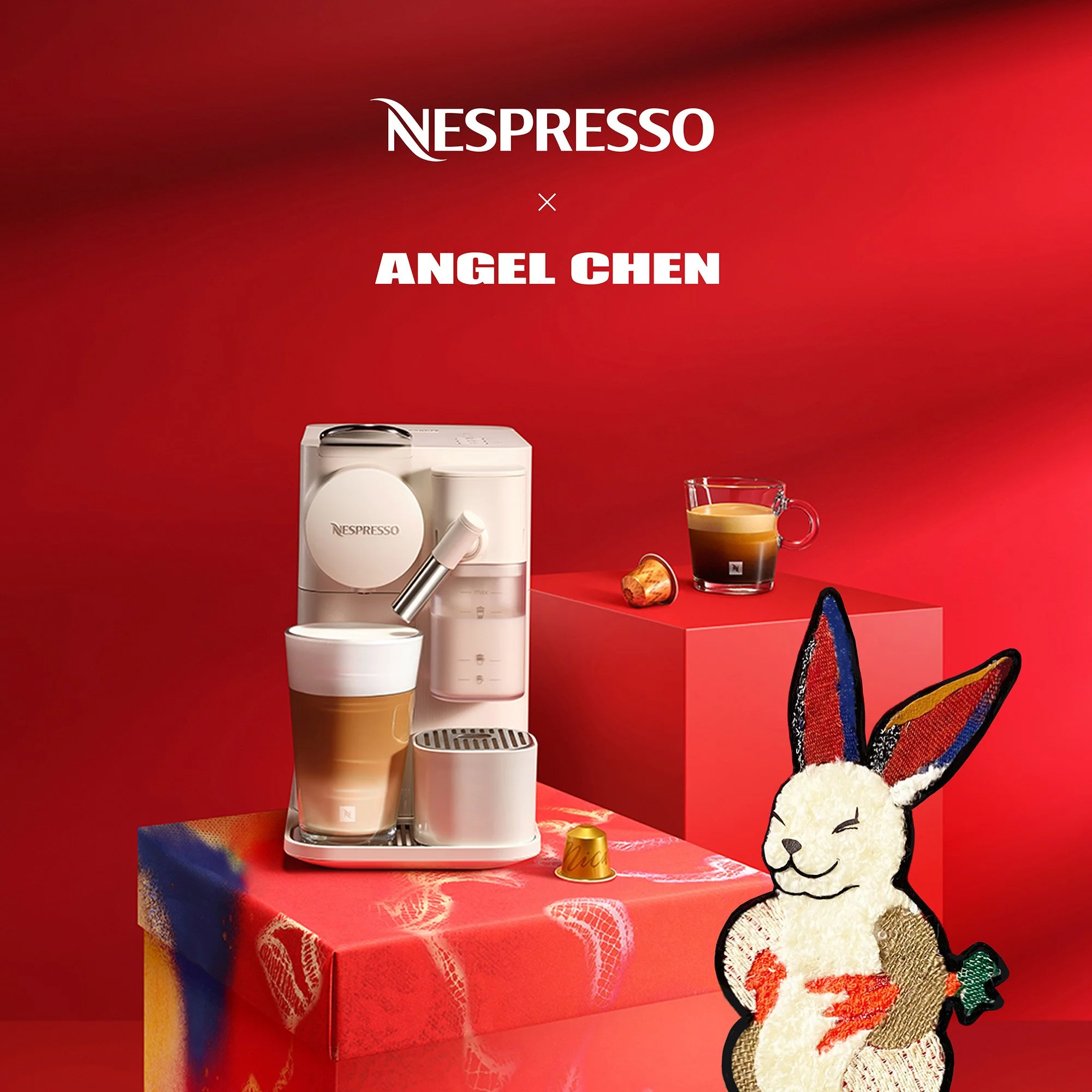 Nespresso coffee machine with a latte, Nespresso coffee capsules, and a plush rabbit toy with colorful ears on a red background.
