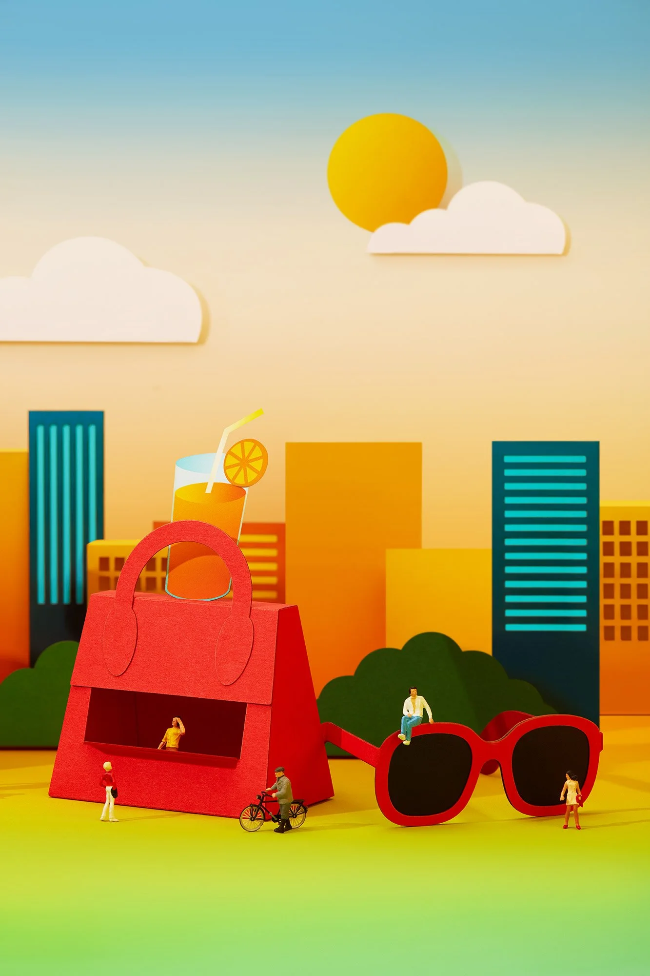 Colorful cartoon-style cityscape with oversized sunglasses, a red handbag, small human figurines, a beverage with a straw and orange slice, and a backdrop of tall buildings and a sun with clouds.