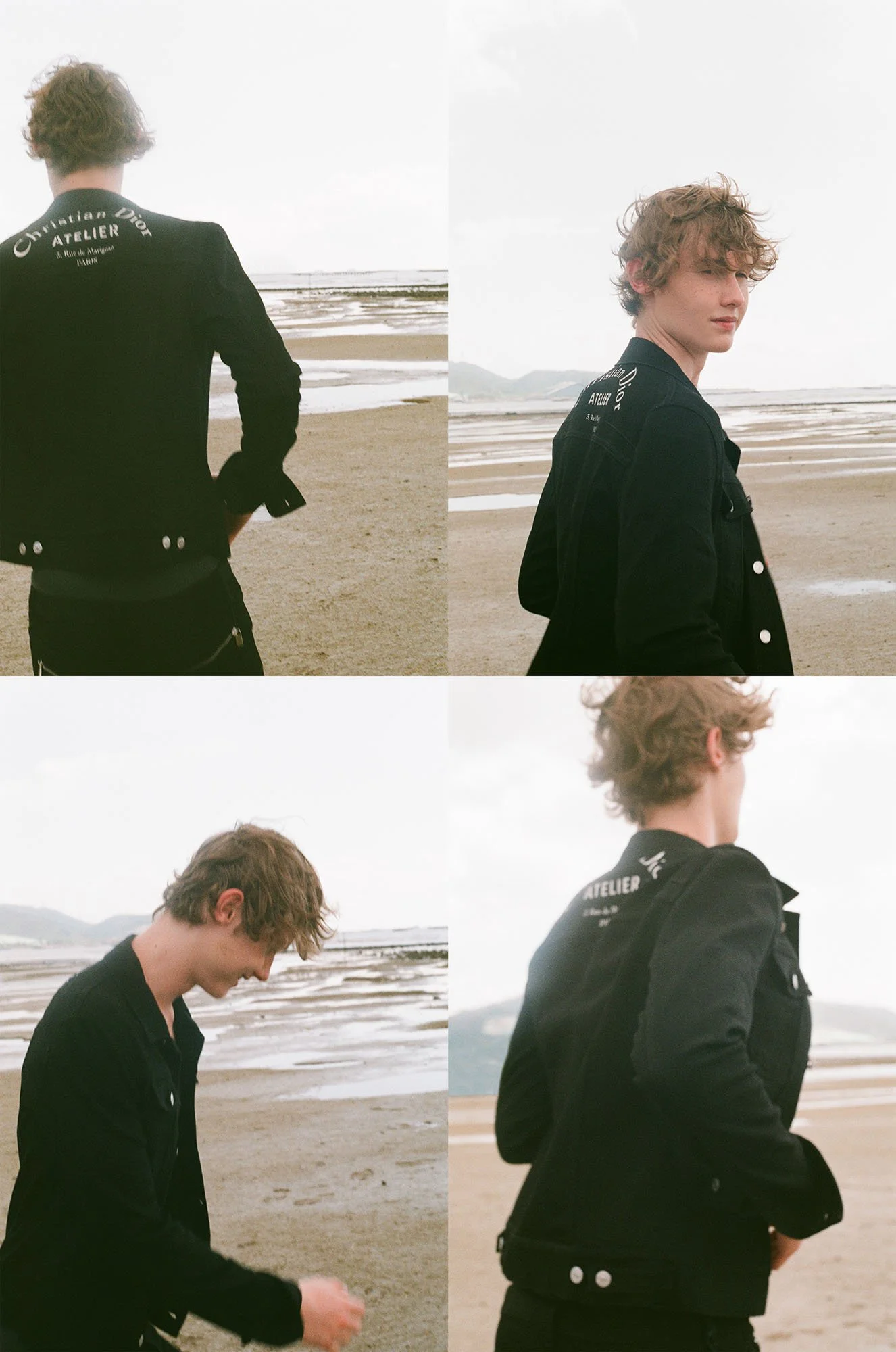 A young man with curly hair wearing a black denim jacket at the beach, standing on sand with water and mountains in the background, shown from multiple angles.