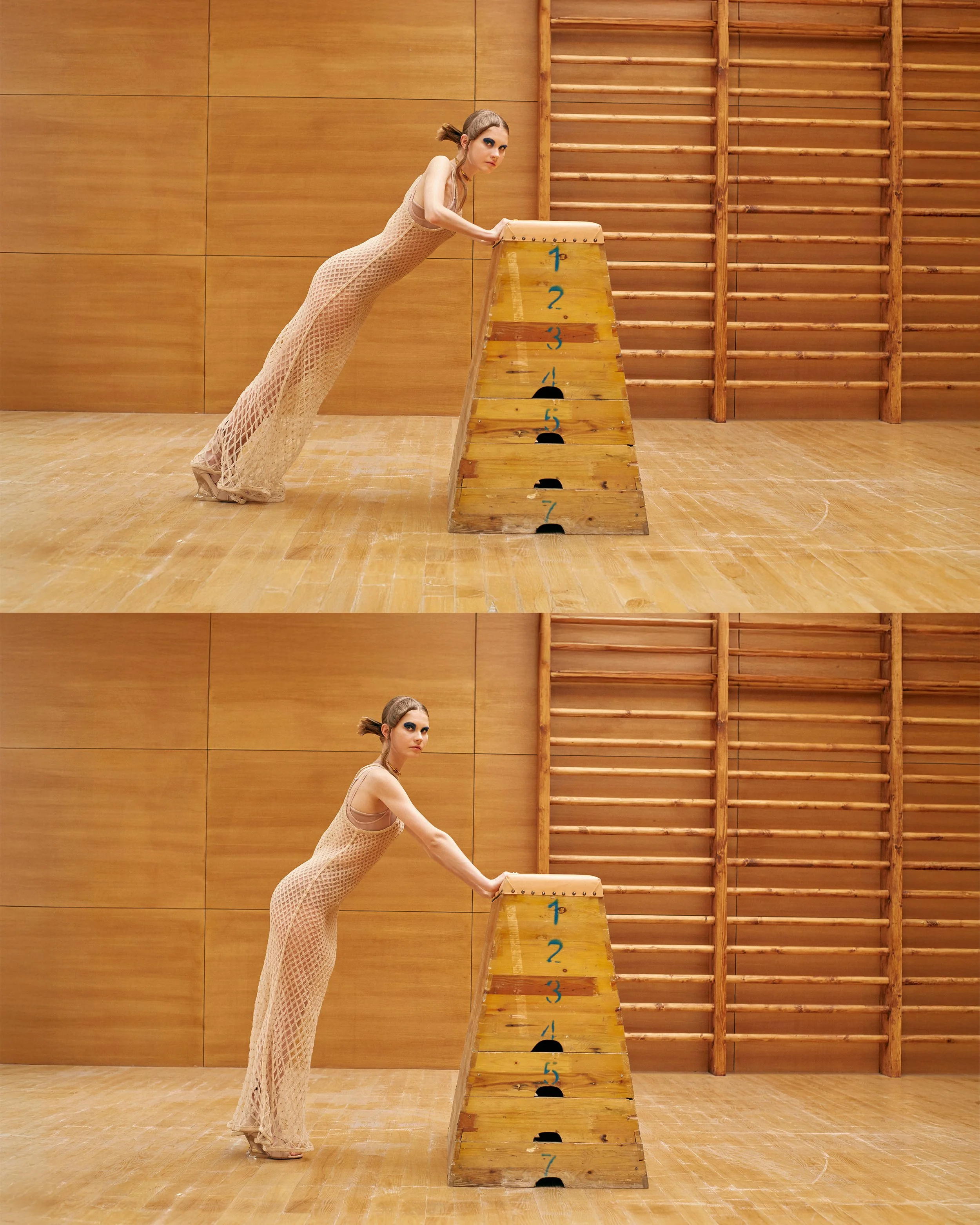 A woman in a long beige dress leaning on a wooden gymnastic vaulting table in a gymnasium with wooden floor and wall bars, focusing at the camera in the second photo.