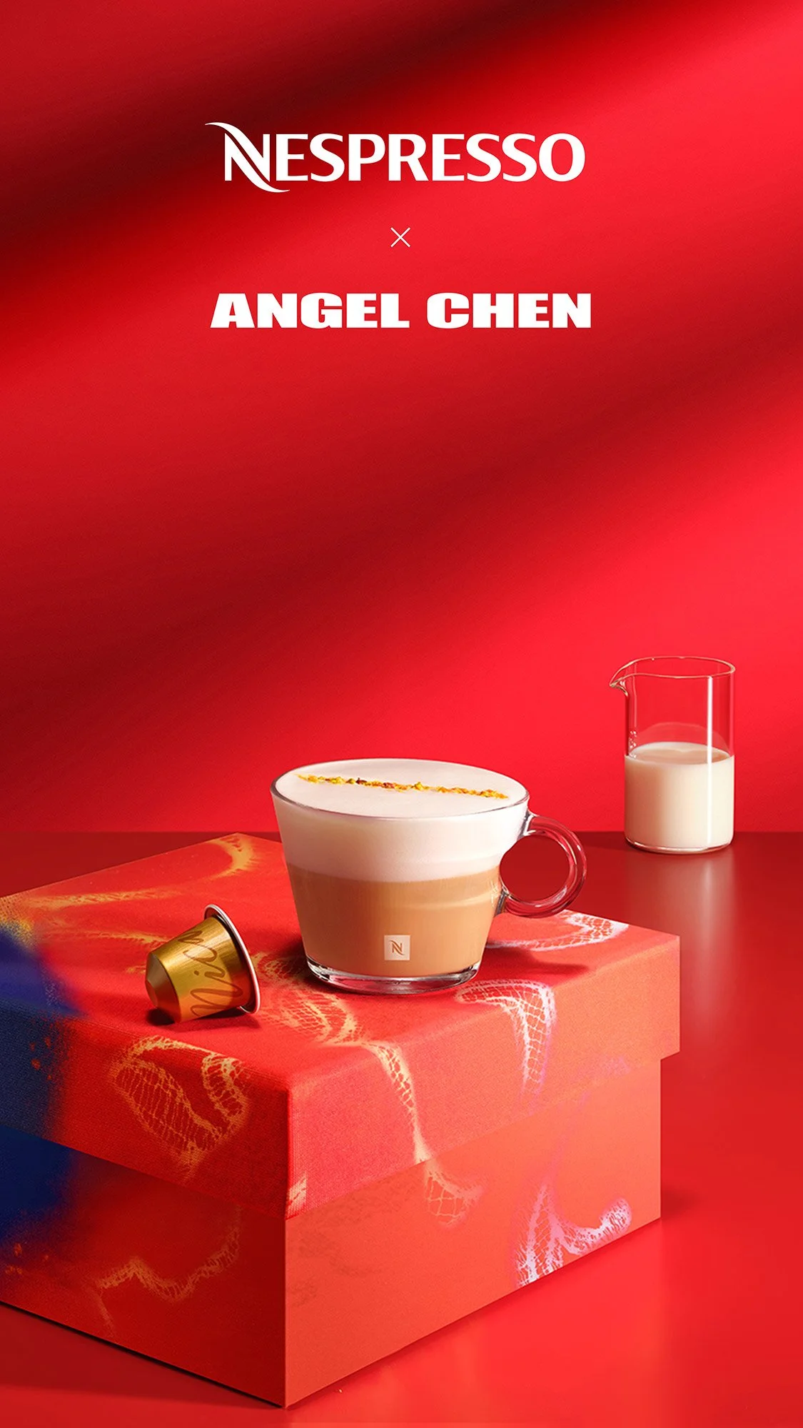 Nespresso logo with a cup of coffee, a small pitcher of milk, and a coffee capsule on a red box against a red background.