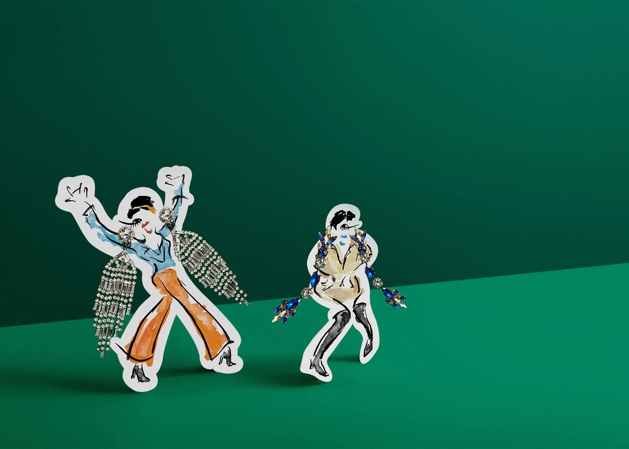 Two illustrated cutouts of Elvis Presley, decorated with jewelry, stand on a green surface with a green background.