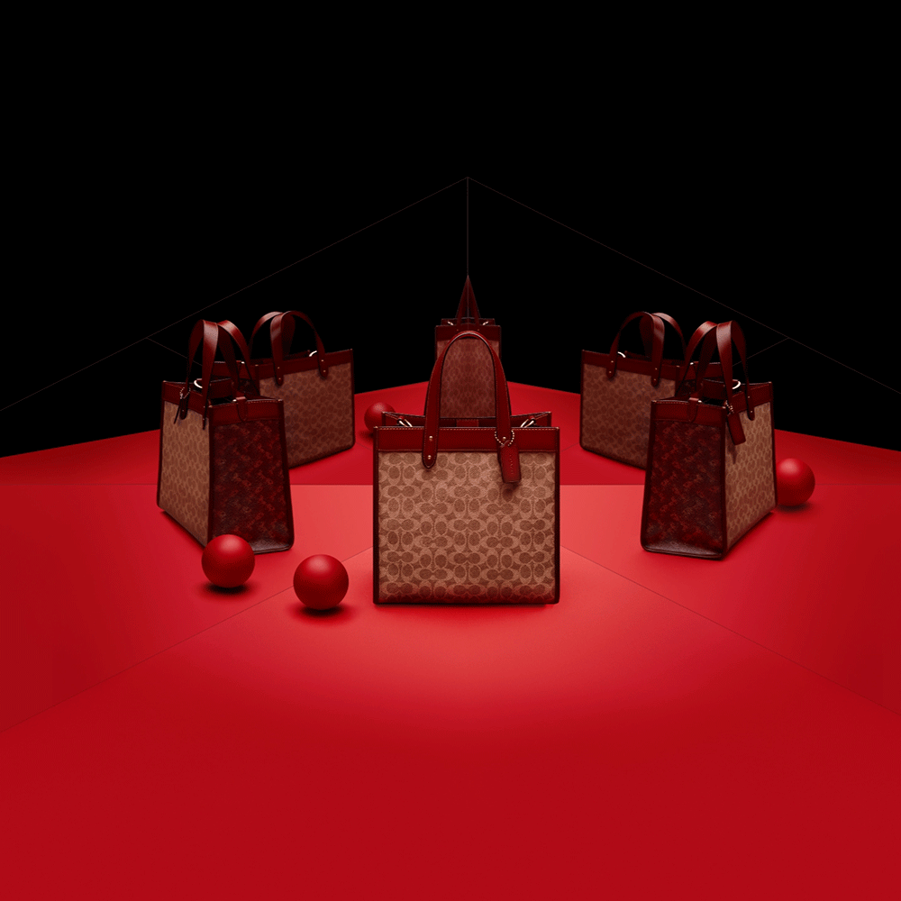 Five designer tote bags arranged in a circular pattern on a red surface, with three red decorative balls.