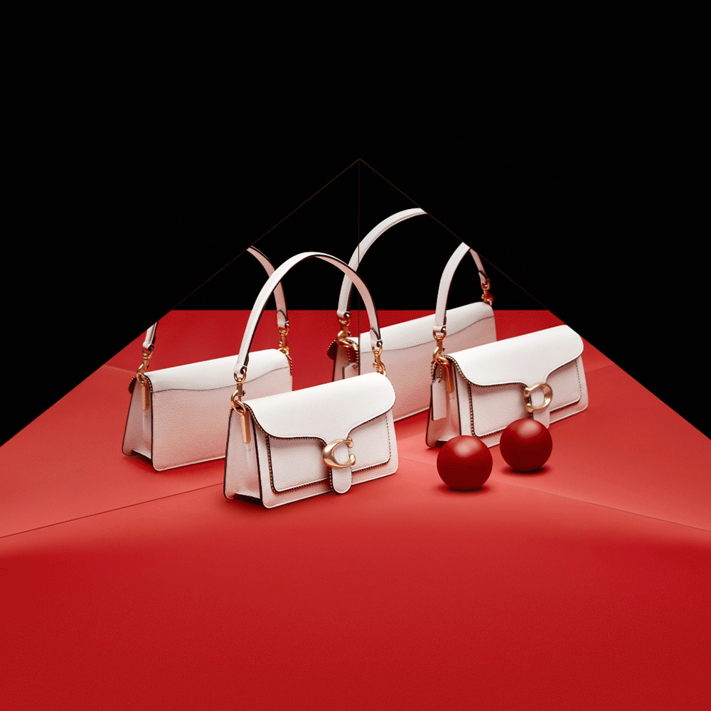 Three white handbags with gold hardware and straps, displayed on a red surface with a mirrored background, accompanied by two red decorative balls.