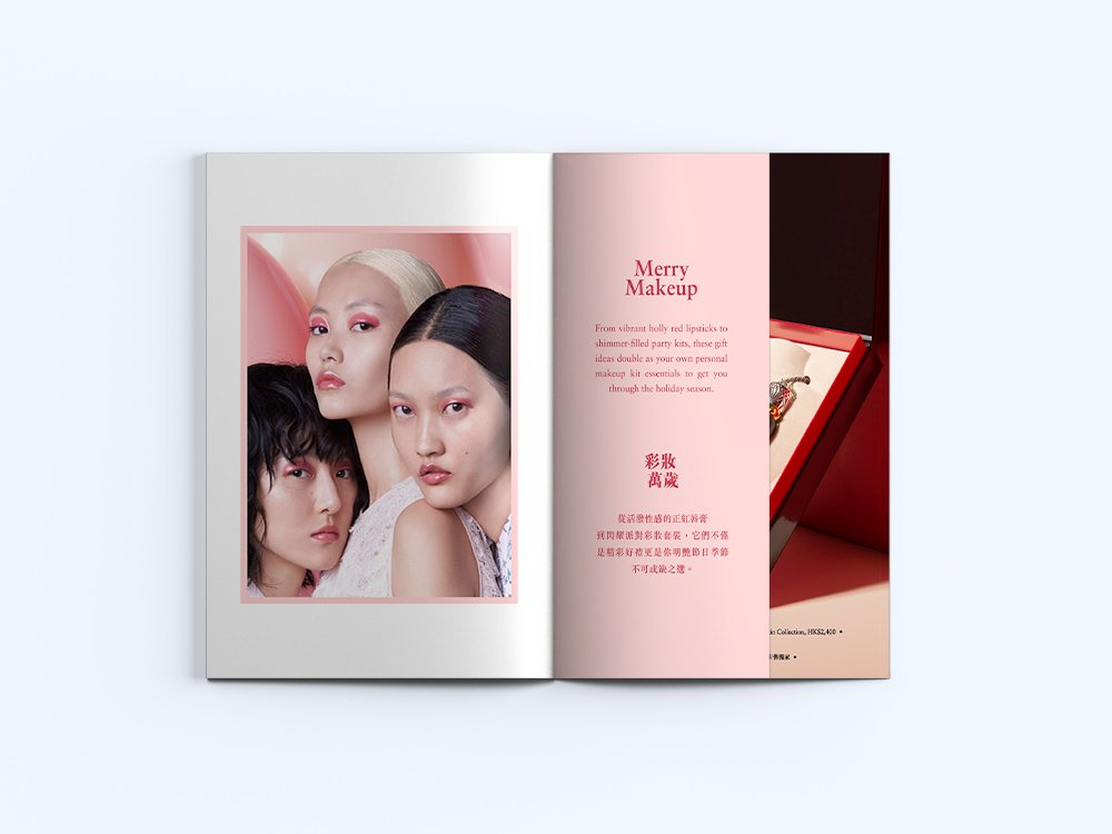 Open makeup magazine showing a photo of three women with bold makeup on left page and a pink page with text about makeup on the right, alongside a jewelry box with necklace on a red background.