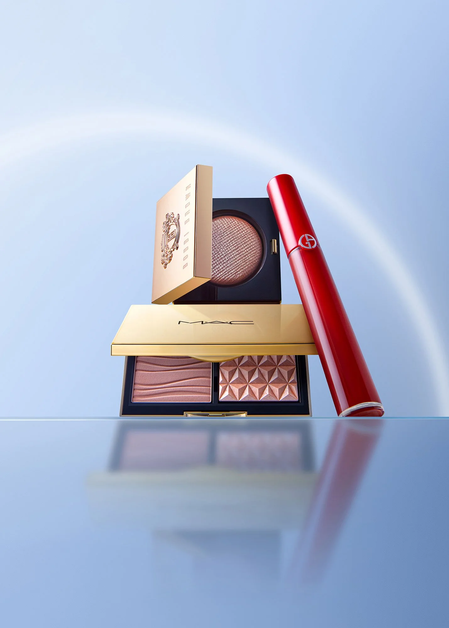 Luxury makeup products including an eyeshadow palette, a cushion compact, and a red lipstick, displayed against a soft blue background with a rainbow in the sky.