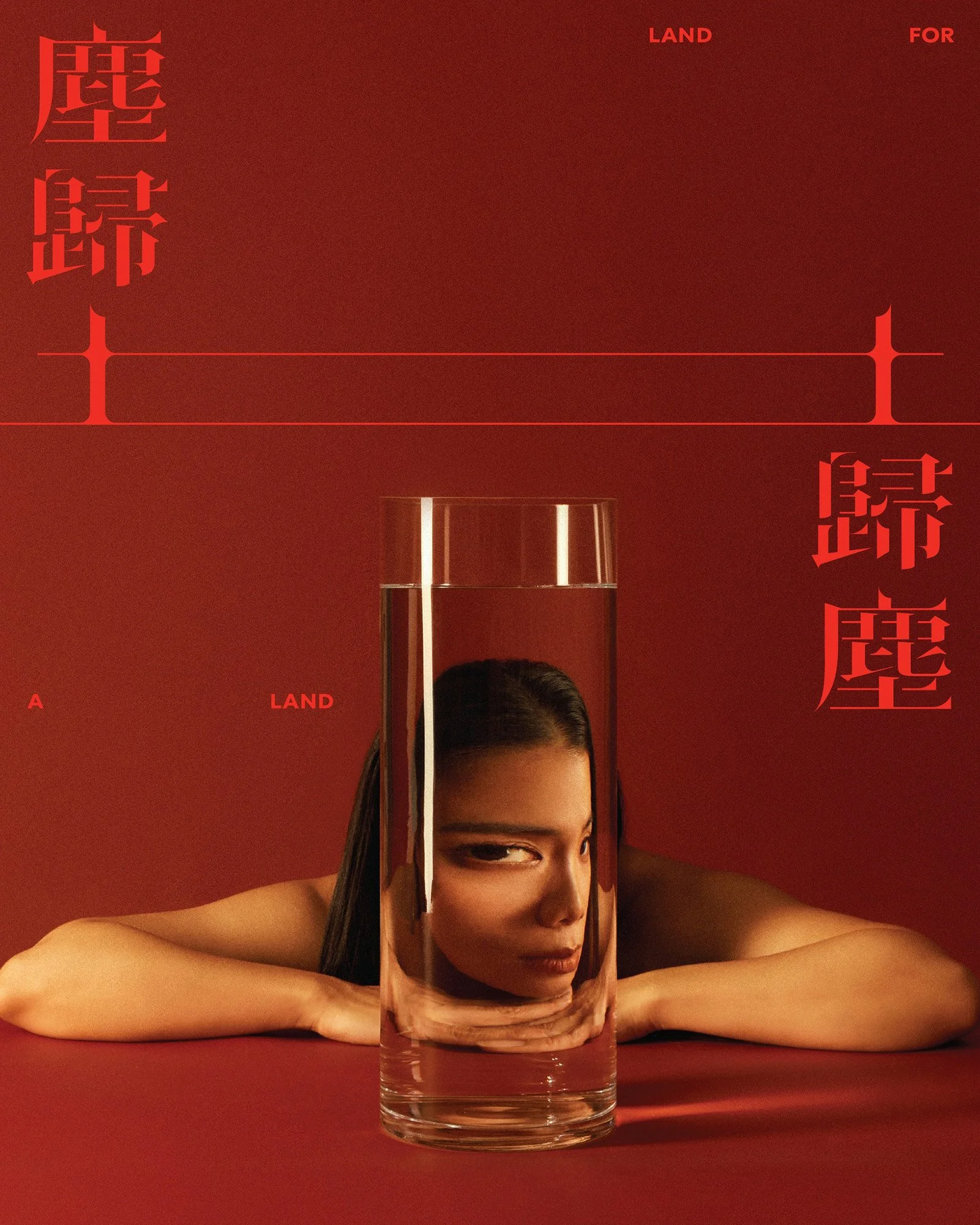 A woman with dark hair resting her head and arms on a red surface, with her face partially submerged and looking through a tall glass of water. The background is red, with text and designs in red and orange.