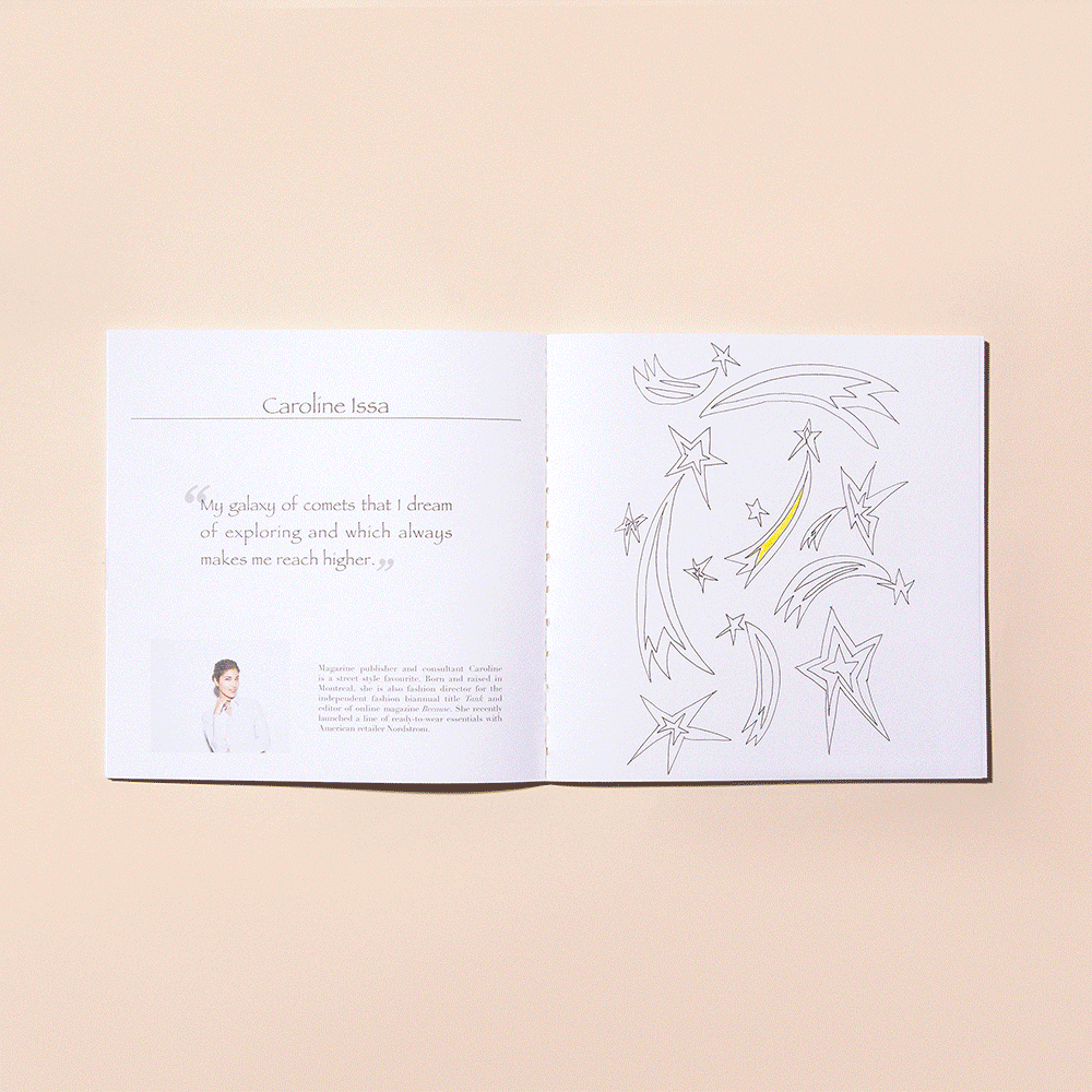 Open book displaying a quote and a page with outlines of stars and comets, some highlighted with yellow color.