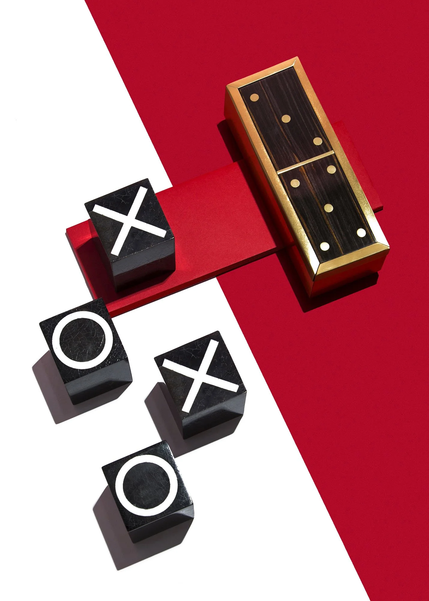 Tic-tac-toe game with black blocks, white X and O, on a red and white background.