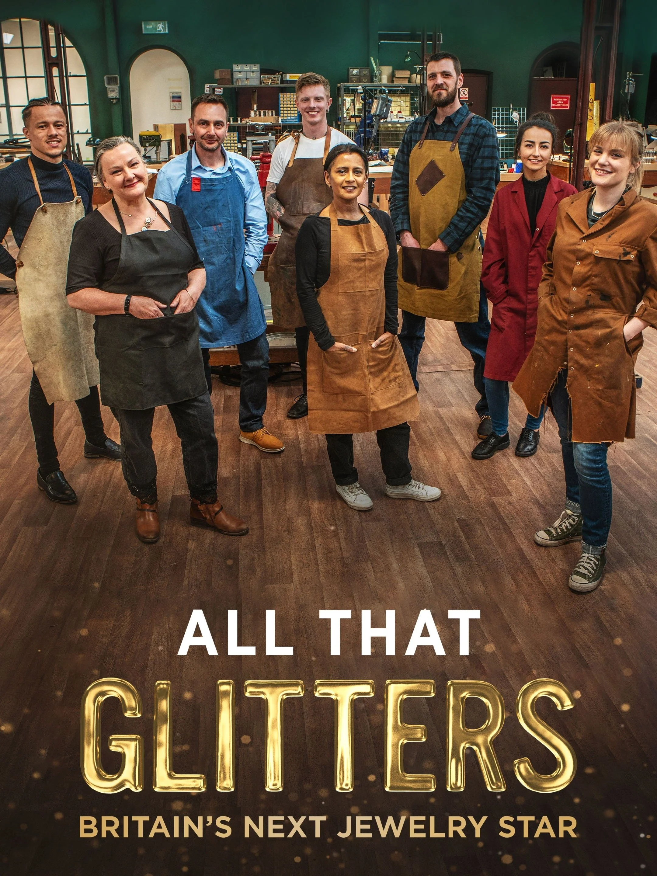 A group of nine diverse people in a workshop or craft studio, dressed in aprons, posing for a photo. The photo is overlaid with the text "All That Glitters," and "Britain's Next Jewelry Star," suggesting they participate in a jewelry-making competition or show.