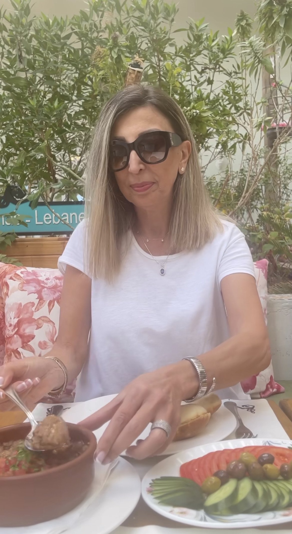 Carmen wearing the Sapphire Pendant during an etiquette video for her audience.