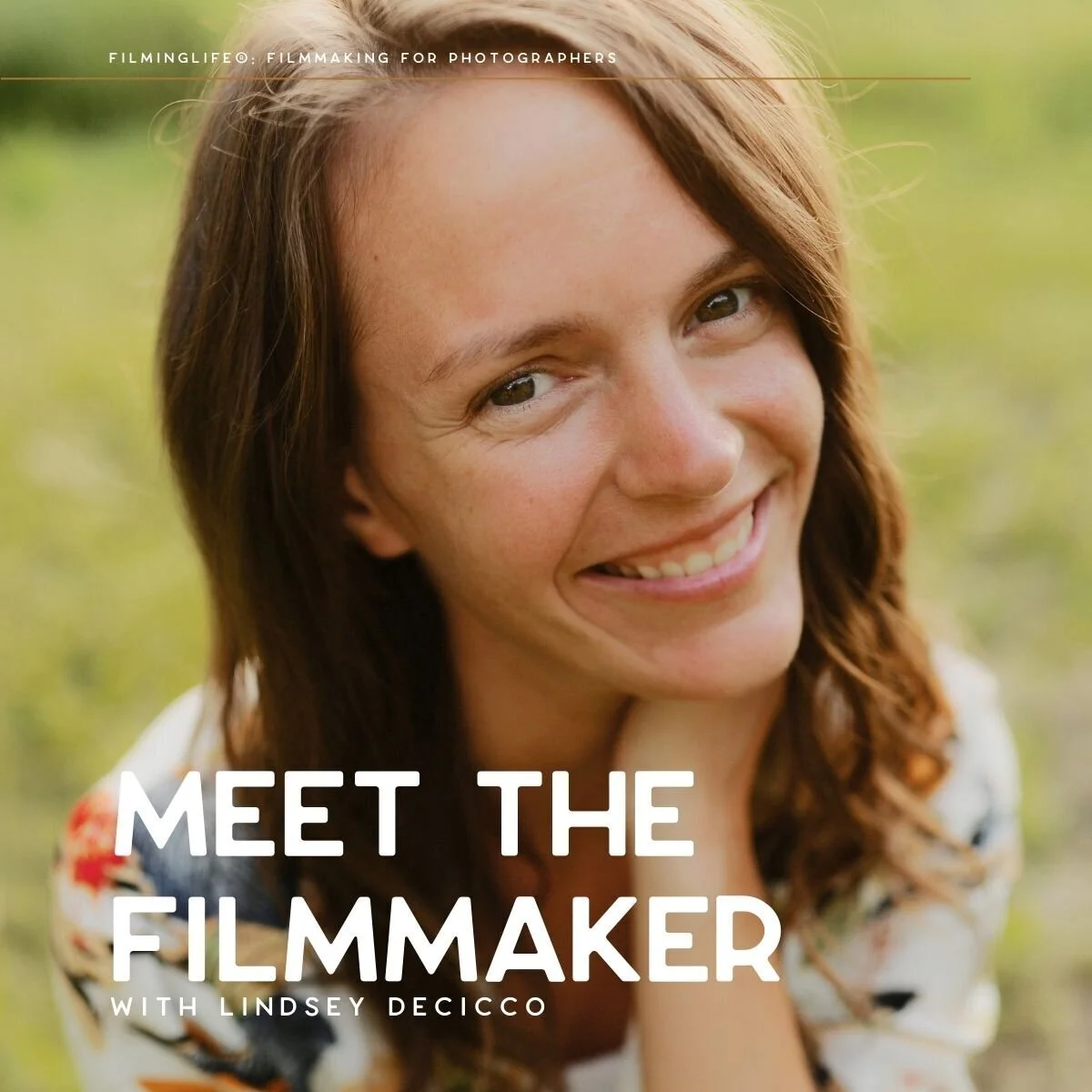 Close-up portrait of filmmaker Lindsey Decicco smiling warmly at the camera while resting her chin on her hand. She is outdoors in soft natural light, with greenery blurred in the background.