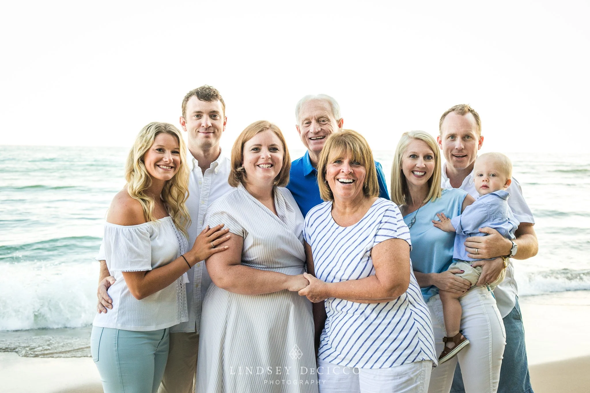 Family group portrait by the ocean