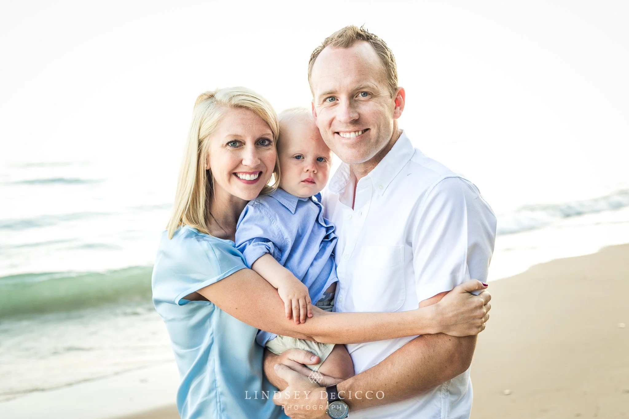Couple with their young child at the beach
